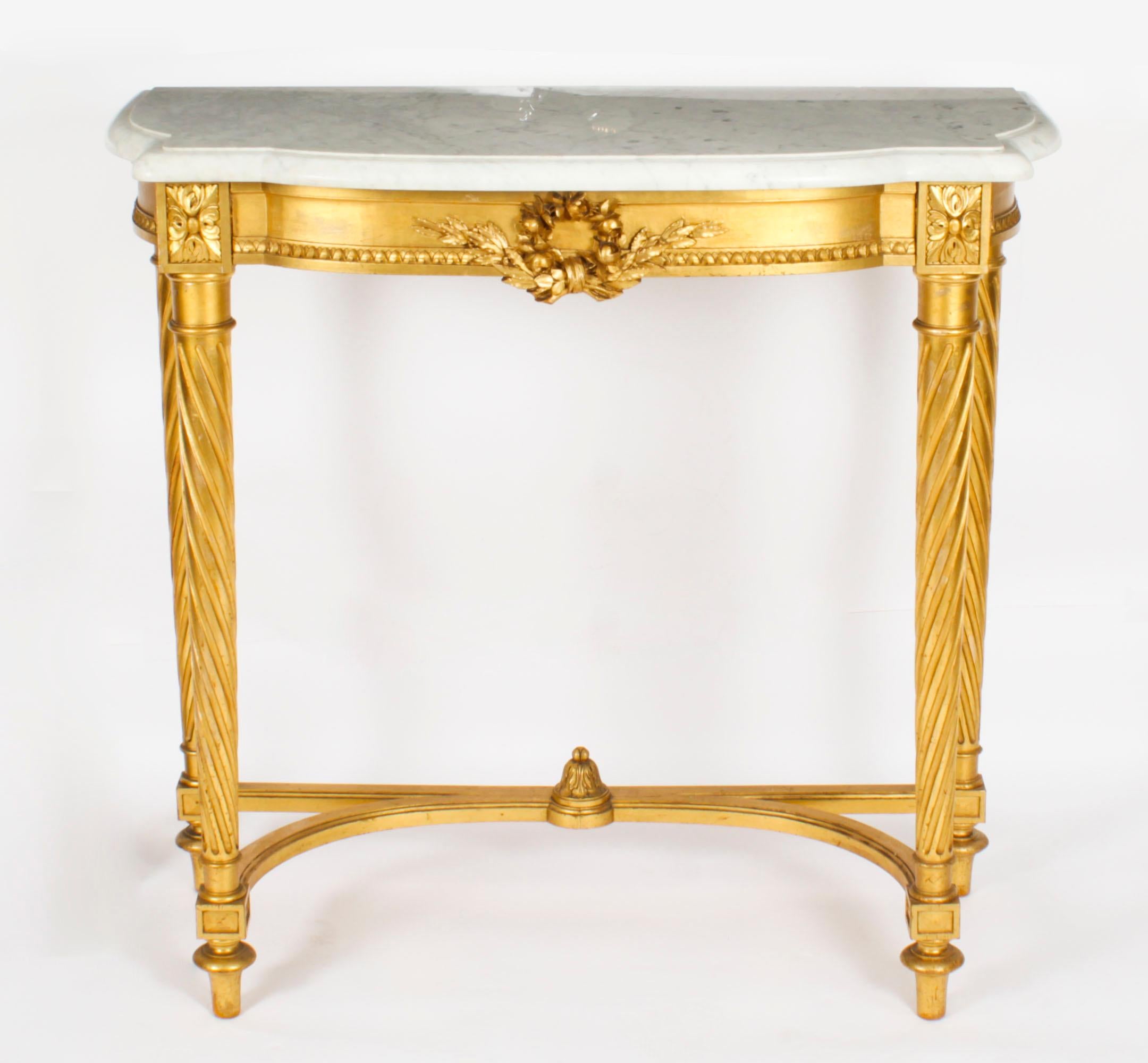 A fine antique French Napoleon III carved giltwood marble topped console table, circa 1870 in date.
 
This finely carved giltwood console table is surmounted with an exquisite shaped rectangular Italian white Carrara marble top above a frieze with