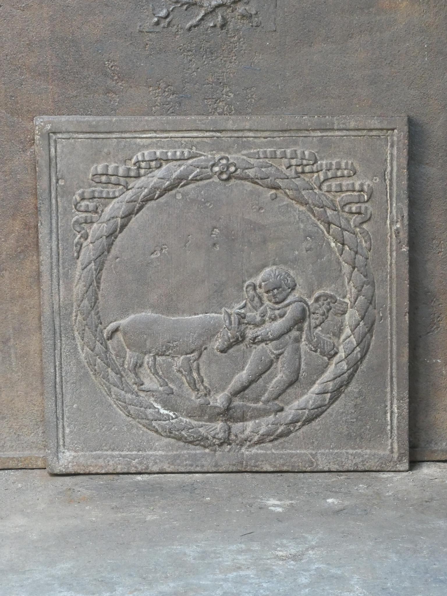 19th century French Napoleon III fireback with a cupid. The fireback is made of cast iron and has a natural brown patina. Upon request it can be made black / pewter. The condition is good, no cracks.















