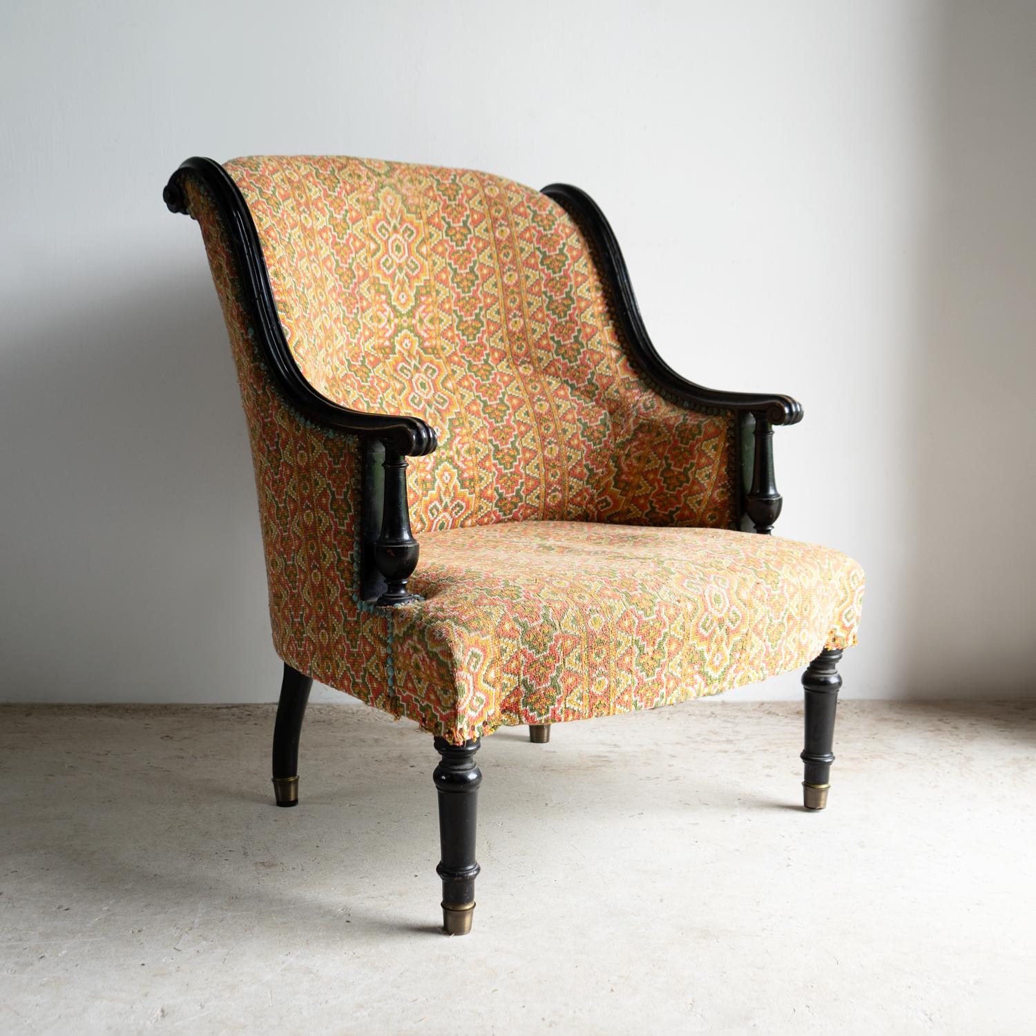 ANTIQUE FRENCH CHAIR

A fairly generously seated and comfortable lounge chair.

With unusual exposed ebonised carved scrolling arms and tuned uprights with baluster details. 

Upholstered in a geometric woven tapestry-type fabric in shades of