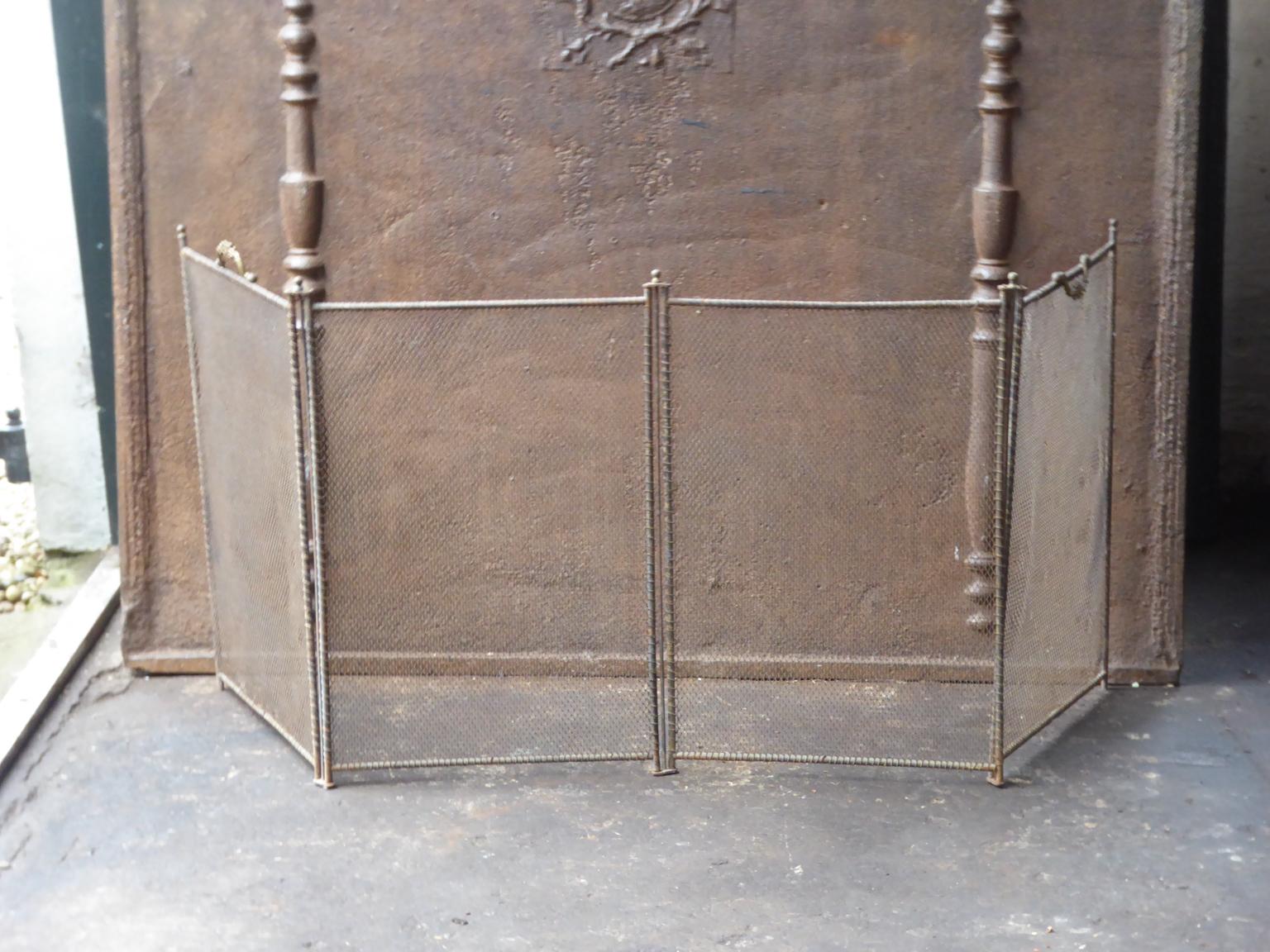 19th century French Napoleon III four-panel fireplace screen. The screen is made of brass, iron and iron mesh. It is in a good condition and is fit for use in front of the fireplace.