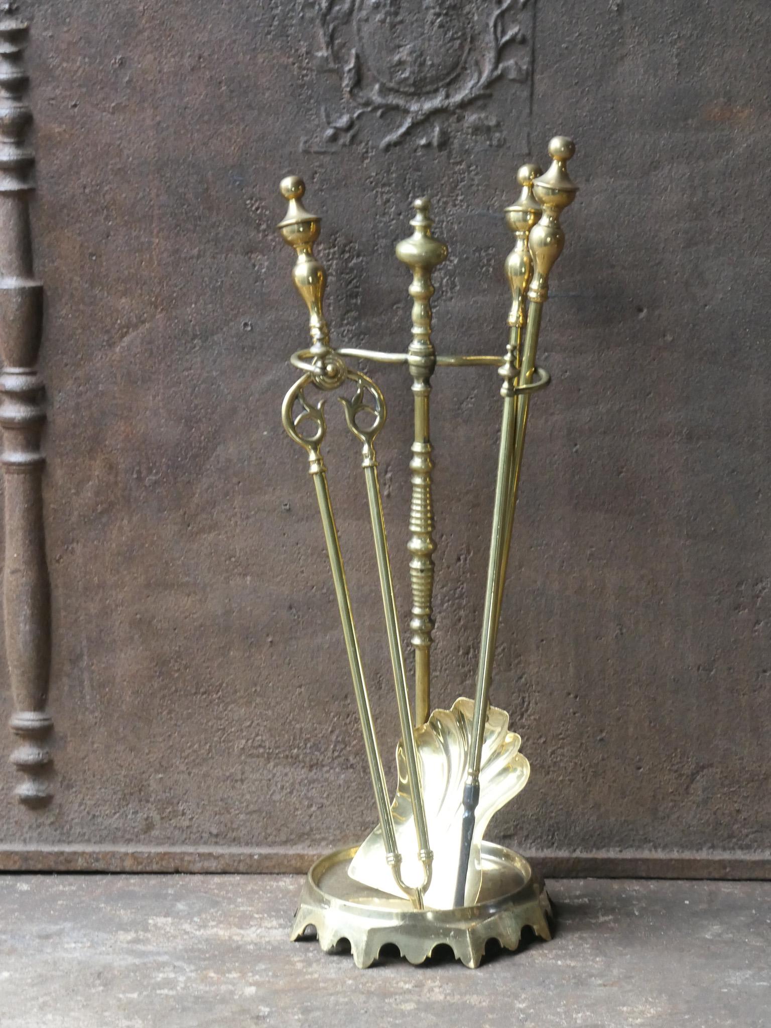 19th century French fireplace tool set. Napoleon III period. The tool set consists of tongs, shovel, poker and a stand. It is made of brass. The set is in a good condition. Fit for use in the fireplace.