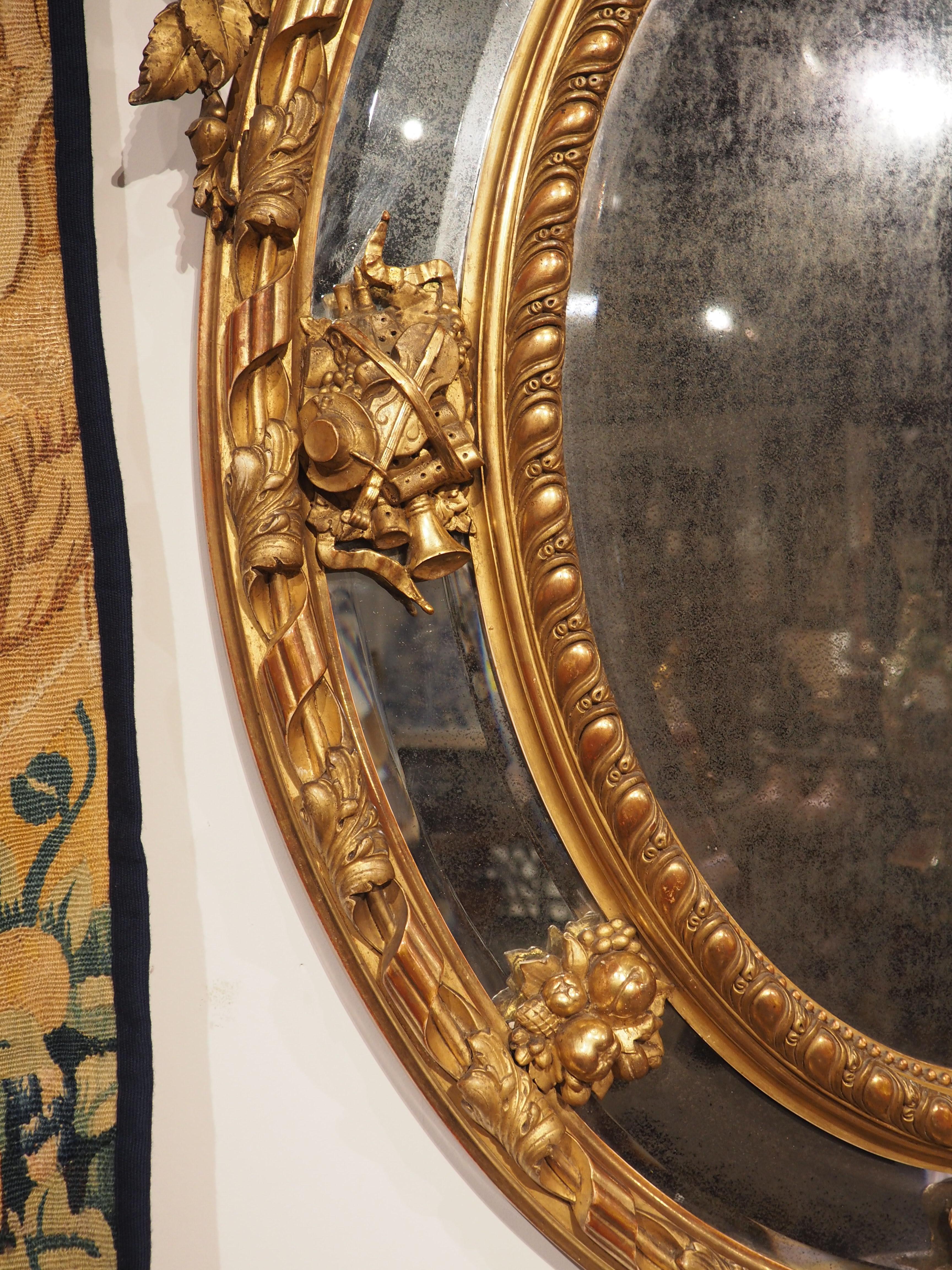 Hand-Carved Antique French Napoleon III Giltwood Mirror with Musical Trophy Decor, C. 1860