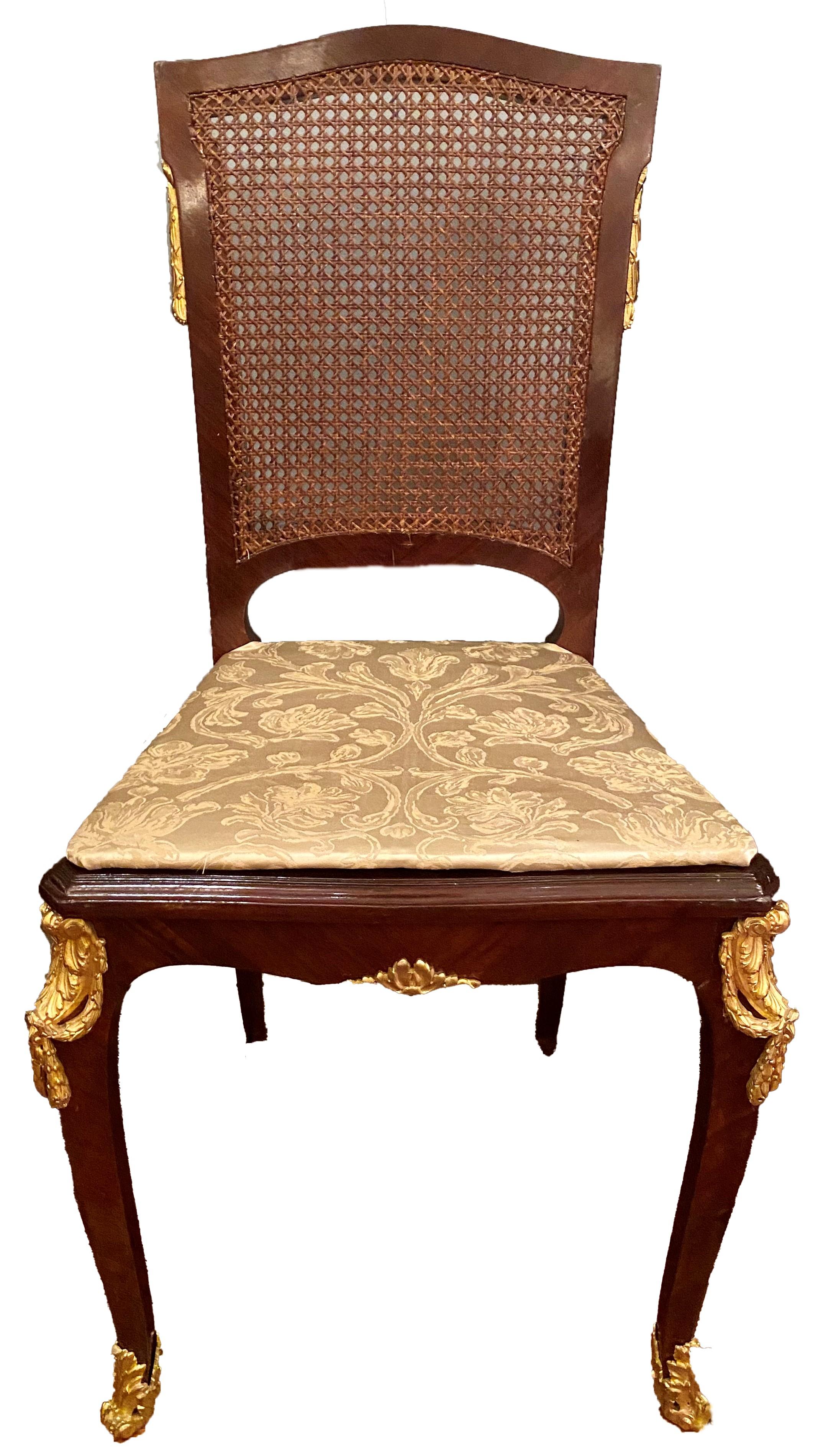 Exceptional antique French Napoleon III style mahogany and ormolu banquet dining table with 12 chairs included, Circa 1890-1900.
Measures: Table 30