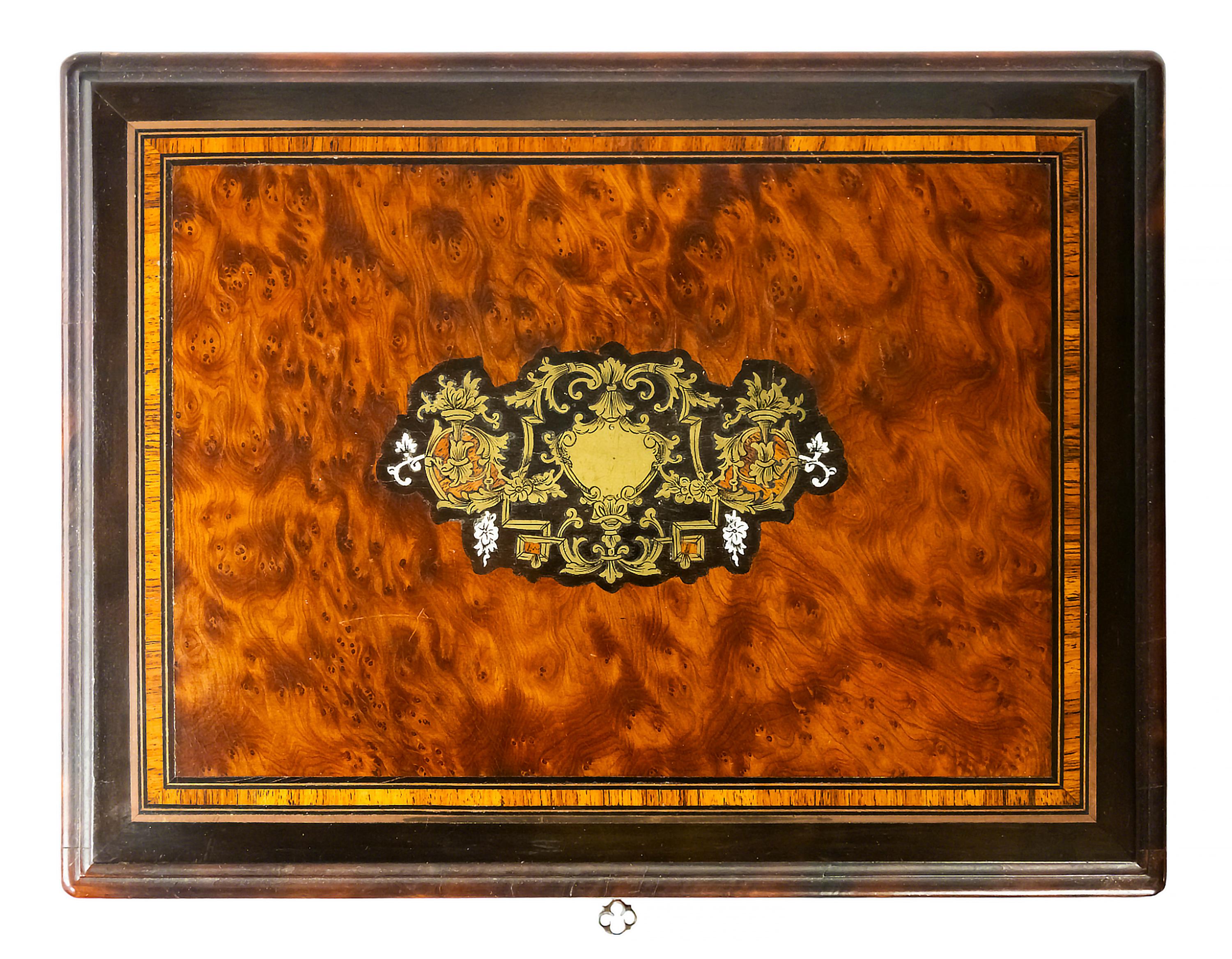 Antique French Boulle marquetry box with cards and game elements inside.
The wooden box is decorated with inlaid brass.
Original key is included.
  