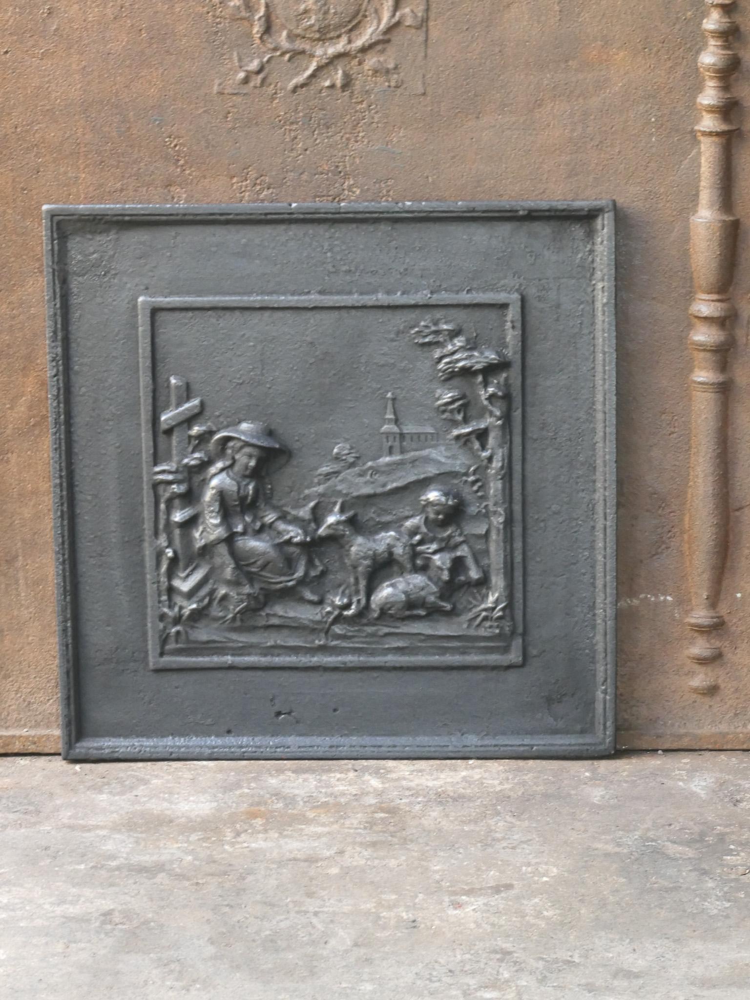 19th century French fireback with a rural scene. The style of the fireback is Napoleon III and it is from that period.

The fireback is made of cast iron and has a natural brown patina. Upon request it can be made black / pewter. The condition of