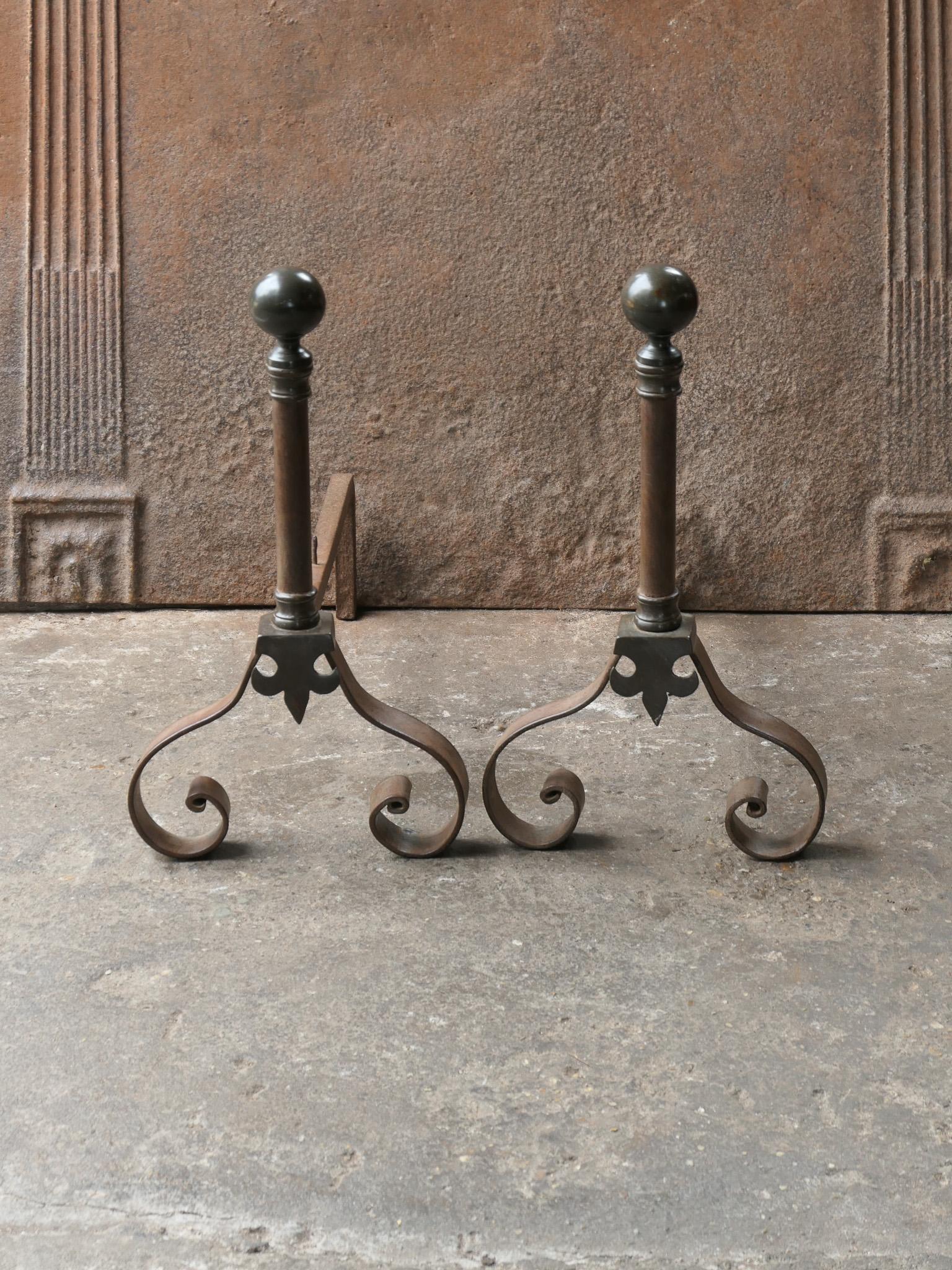 19th-20th century French Napoleon III style fireplace andirons or fire dogs, made of wrought iron and brass. The andirons are in a good condition and are fully functional.