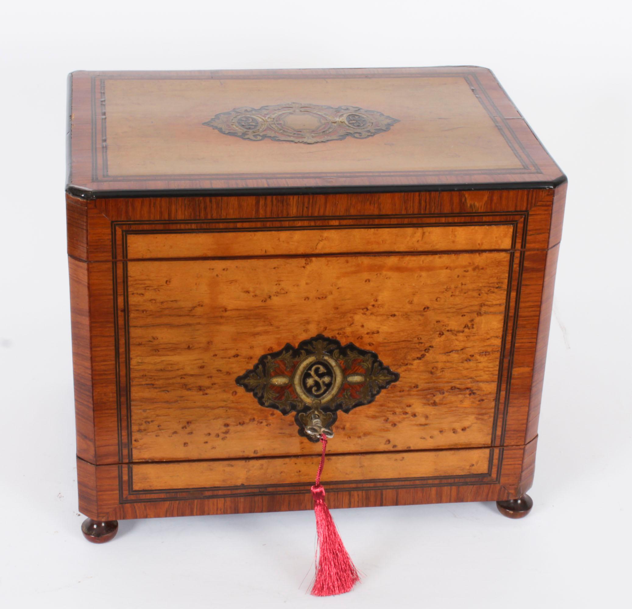 This is an exquisite antique French Napoleon III birdseye maple Tantalus Cave a Liqueur, circa 1860 in date. 

It features brass inlaid decoration on the top and front with tulip wood banding. The hinged lid and the hinged sides open to reveal a