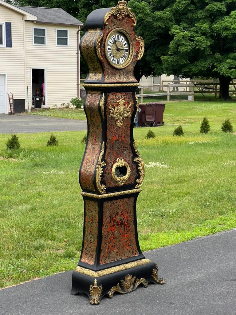 Embark on a journey through time with this striking Antique French Napoleonic Boulle Marquetry Longcase Clock, crafted around the year 1800. This magnificent timepiece is a testament to the lavish aesthetics of the Napoleonic era, showcasing