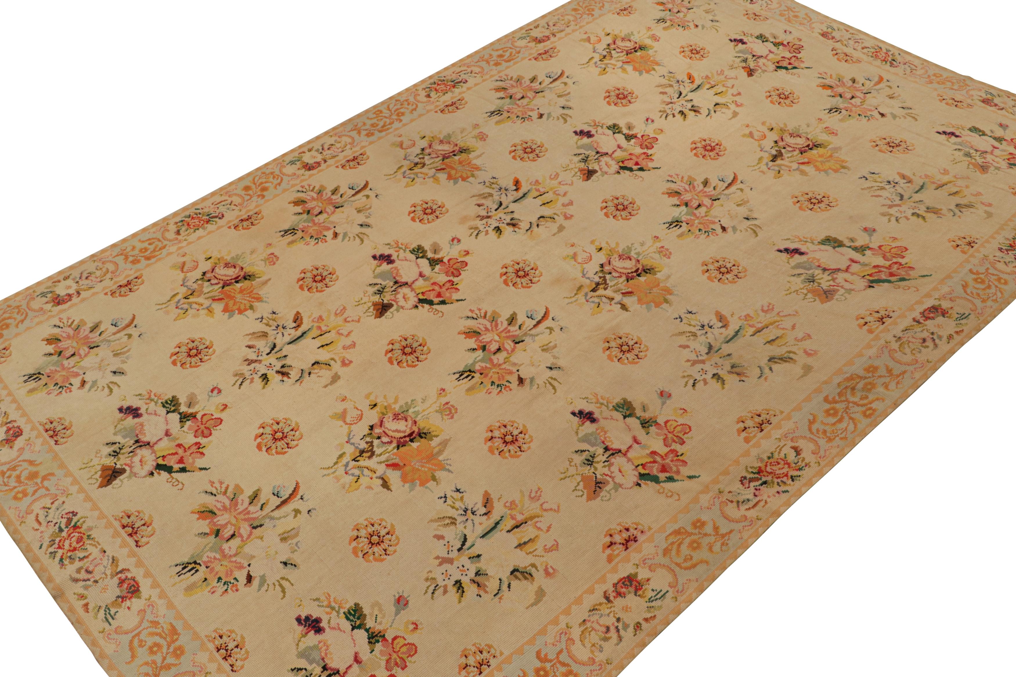 Handmade in wool circa 1920-1930, this 9x15 antique French Needlepoint rug, features a beige field with cream undertone, and orange and pink accents in the botanical themed floral patterns. 

On the design: 

Admirers of the craft will appreciate