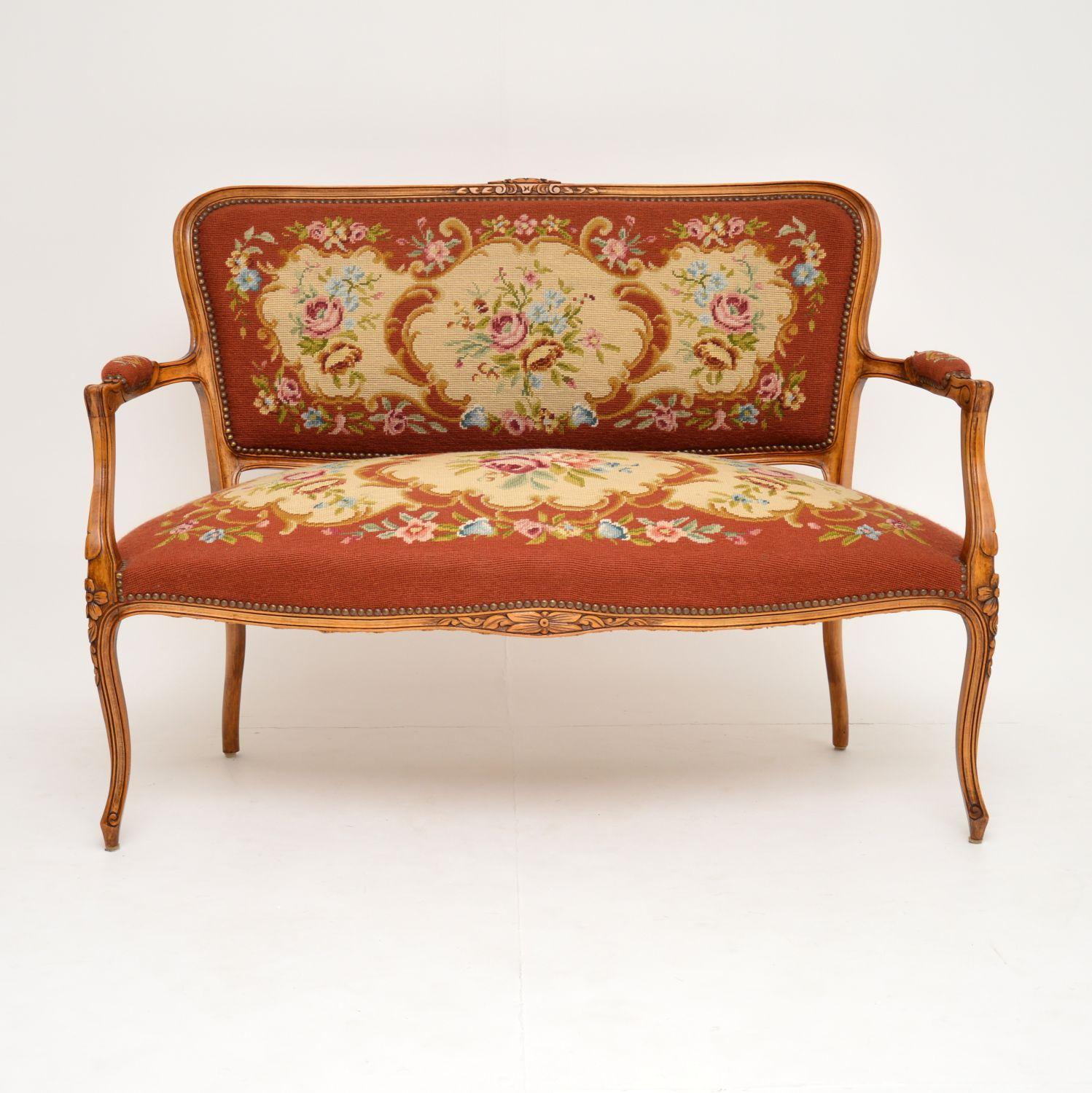 This antique French sofa is in excellent original condition & dates from around the 1890-1910 period.

What’s nice, is that it still has the original needlepoint fabric which is in very good condition. It has a sturdy solid walnut or beech frame