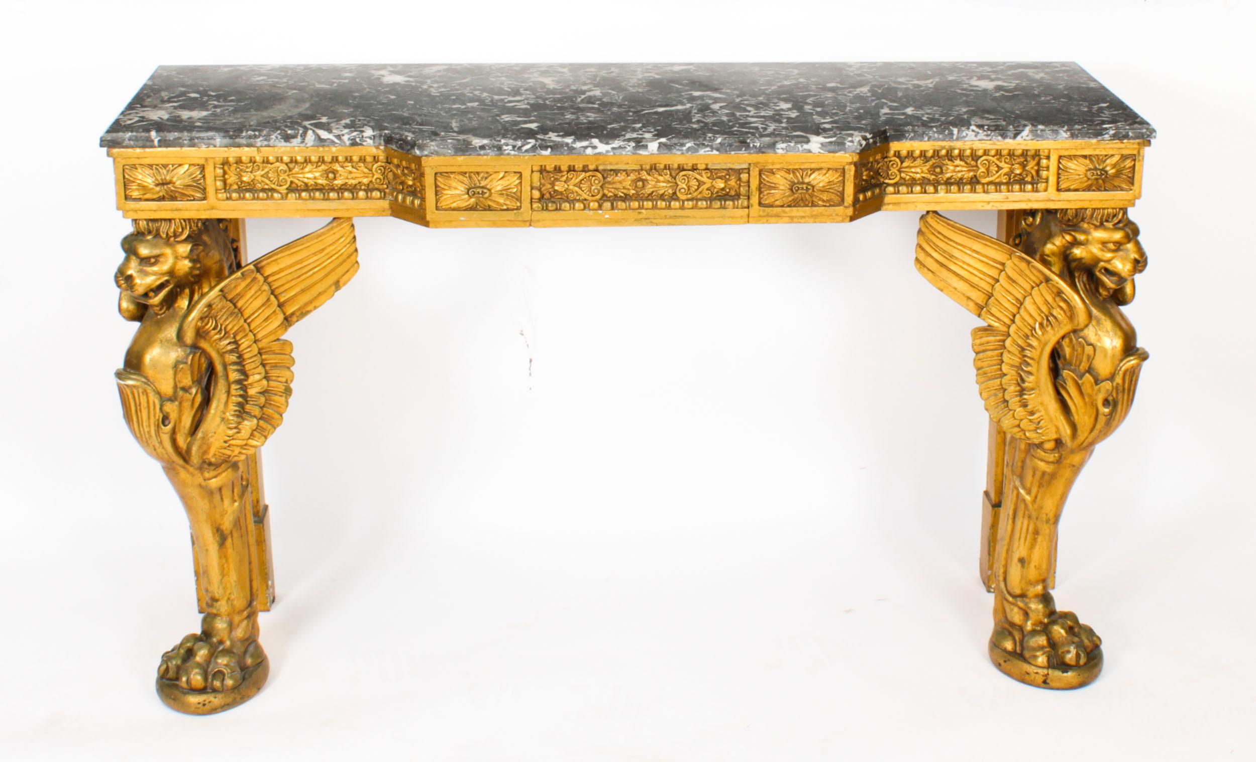 This is a beautiful antique French Neo-Classical giltwood marble topped console table, Circa 1820 in date.
 
The table has a wonderful shaped variegated grey and white grain marble top above a carved and gilded frieze decorated with panels of