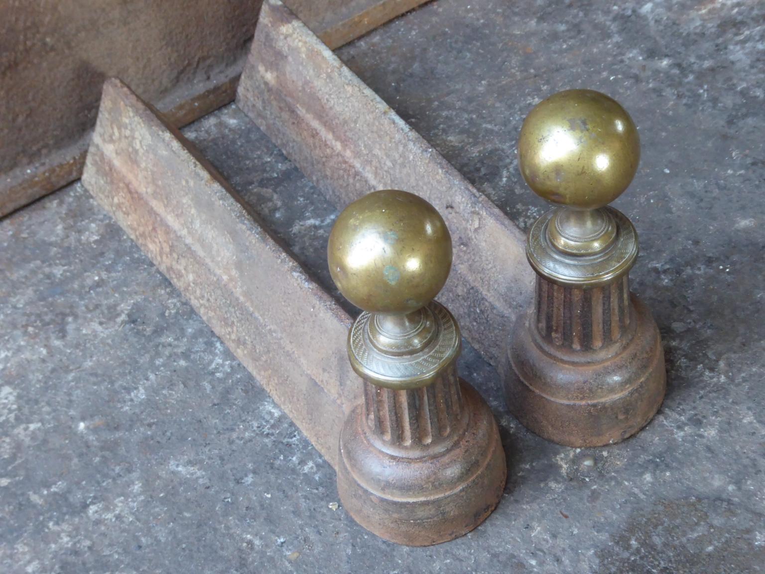 19th century French neoclassical andirons made of brass and cast iron. The andirons are in a good condition.