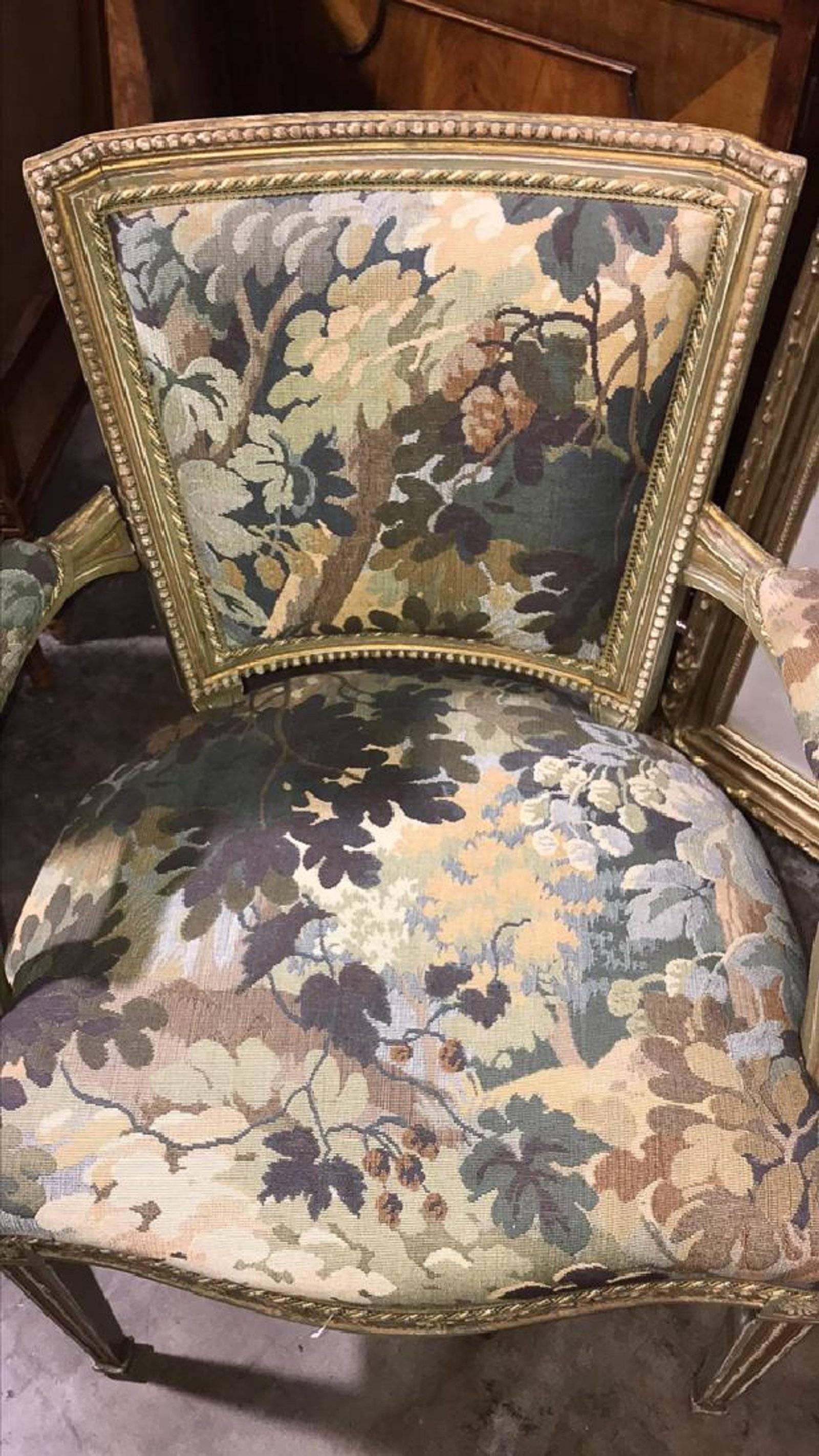 Elegant late 19th century French neoclassical style armchair with superbly carved frame with old painted finish. Upholstered in a custom Lee Jofa floral fabric.