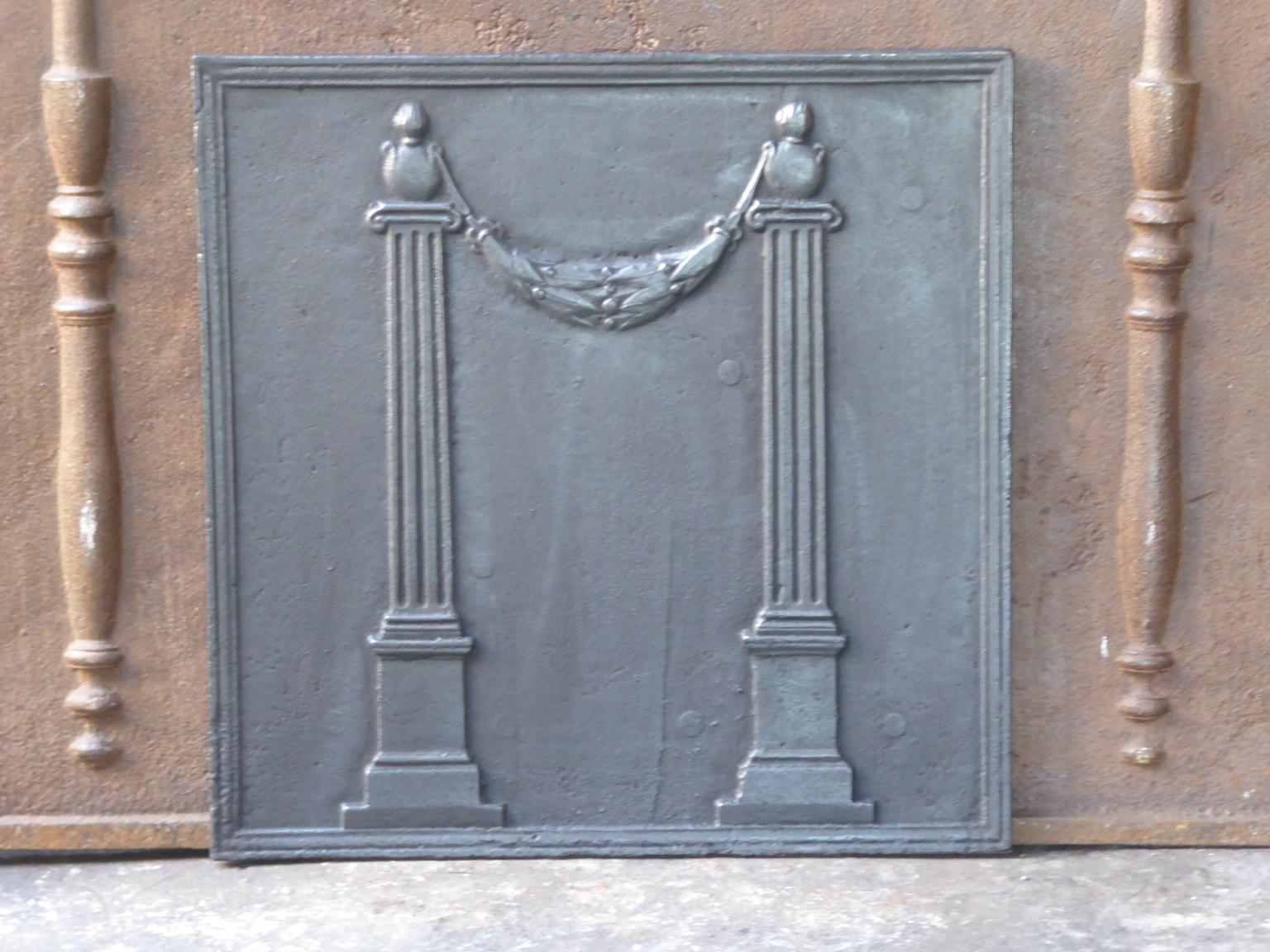 18th-19th century French neoclassical fireback with two pillars of Freedom. They symbolize one of the three values of the French Revolution, liberty.

The fireback is made of cast iron and has a black / pewter patina. It is in a good condition and