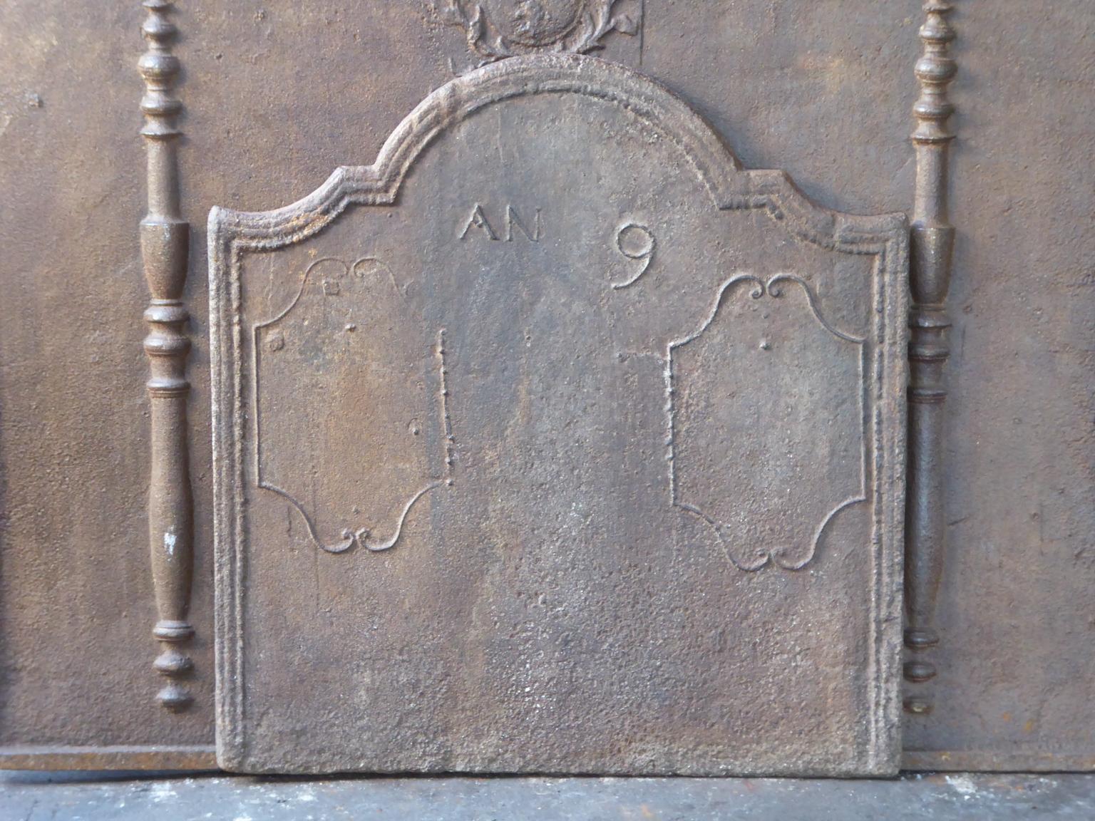 Early 19th century French neoclassical fireback to commemorate the ninth year of the French revolution. 

The fireback is made of cast iron and has a natural brown patina. Upon request it can be made black / pewter. It is in a good condition and