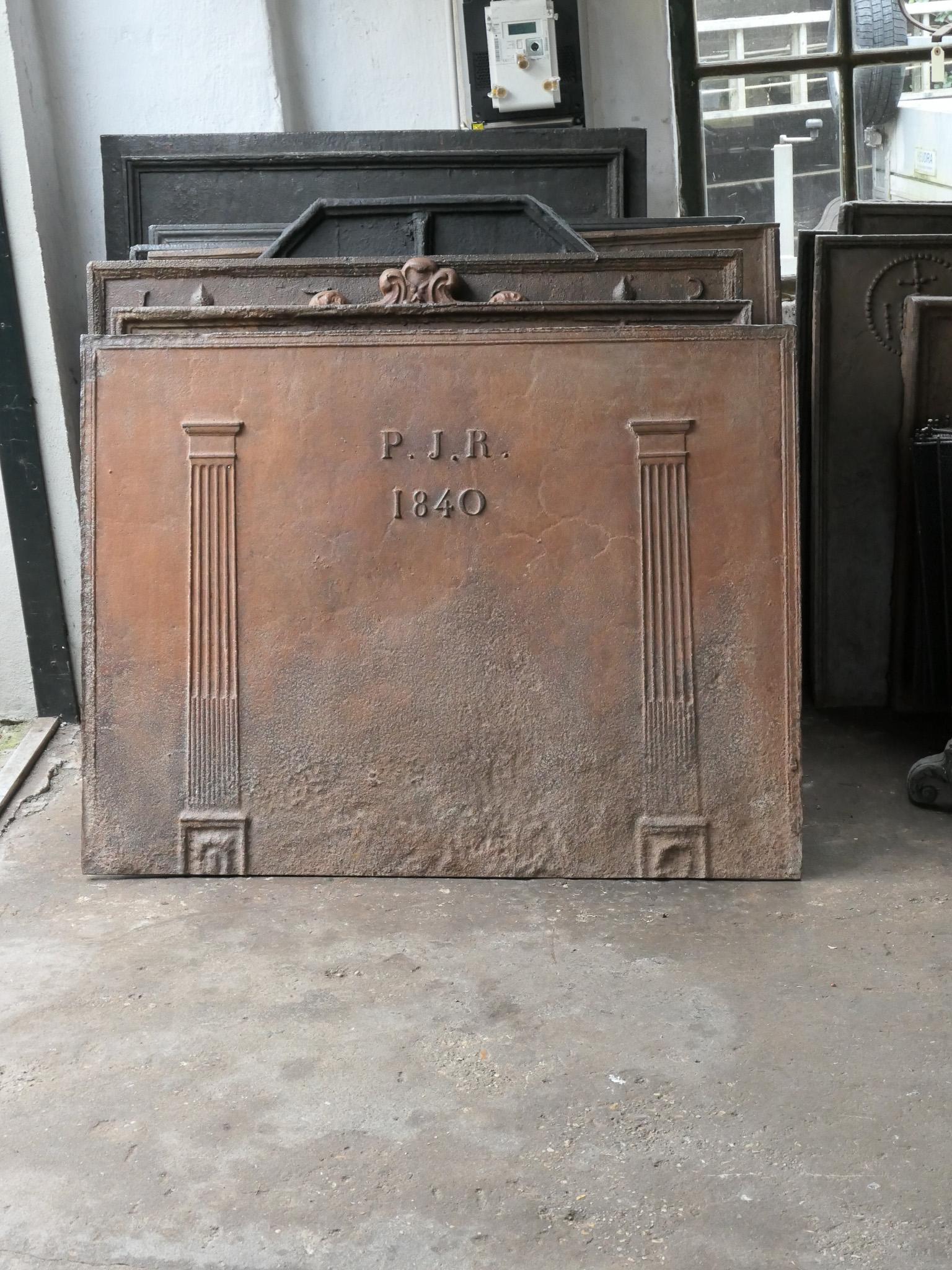 19th century French neoclassical period fireback. The pillars symbolize freedom, one of the three values of the French Revolution. The date of production, 1840, is also cast in the fireback.

The fireback is made of cast iron and has a brown patina.