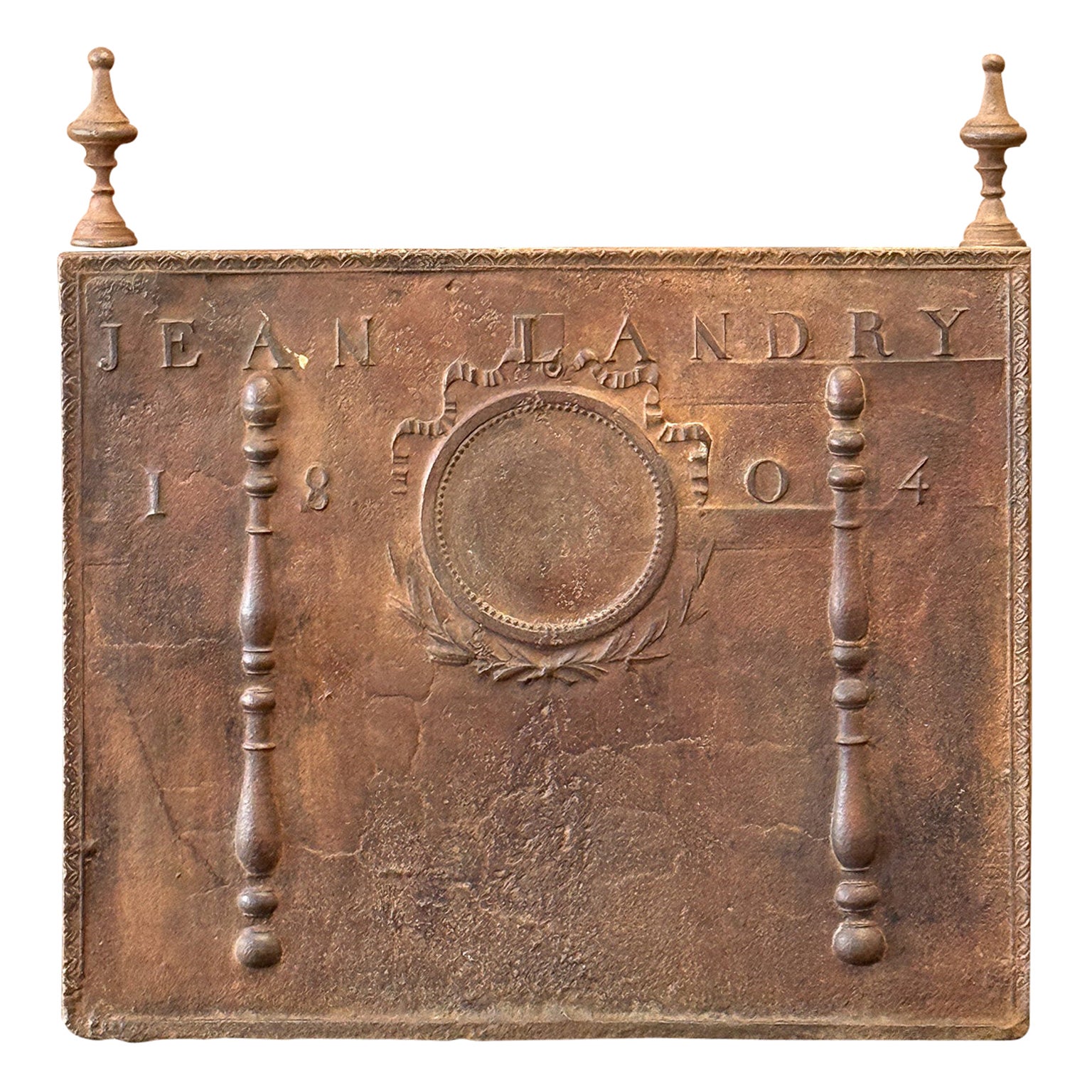 19th century French Neoclassical Period fireback with two pillars of freedom and a decoration. The pillars symbolize the value liberty, one of the three values of the French revolution. Also the name of the person who commissioned the production of