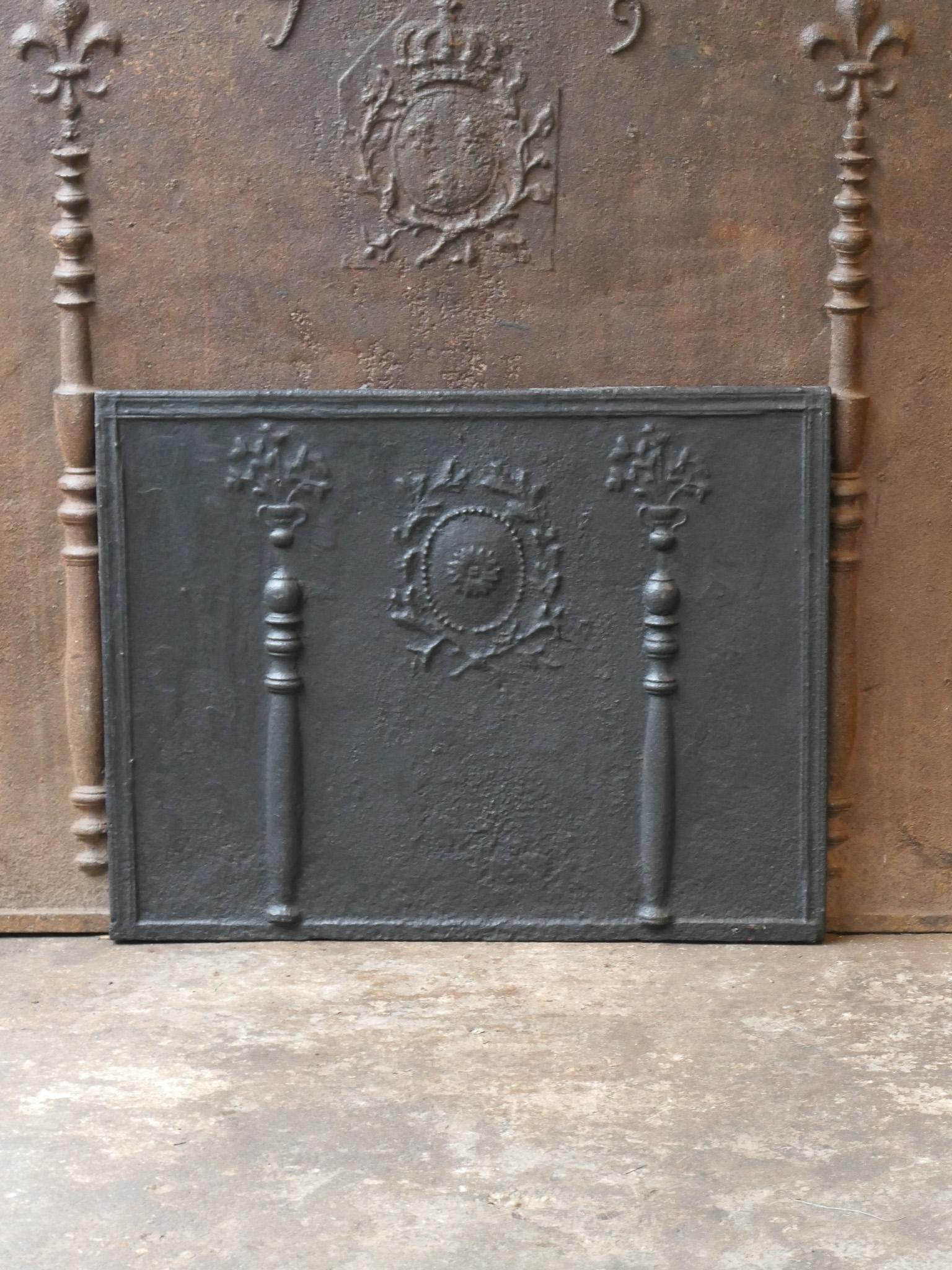 Beautiful 18th century French Neoclassical fireback with flower decorations and two pillars. The pillars refer to the club of Hercules and Stand for strength and the unknown. Towards the end of the 18th century and the start of the Louis XV style,
