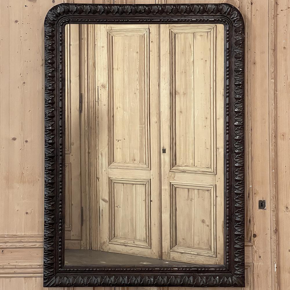 Antique French neoclassical Hand Carved mirror is a splendid combination of the tailored Louis Philippe architecture melded with classically-inspired adornment! Gently rounded upper corners above contrast with the 90 degree corners of the base, with