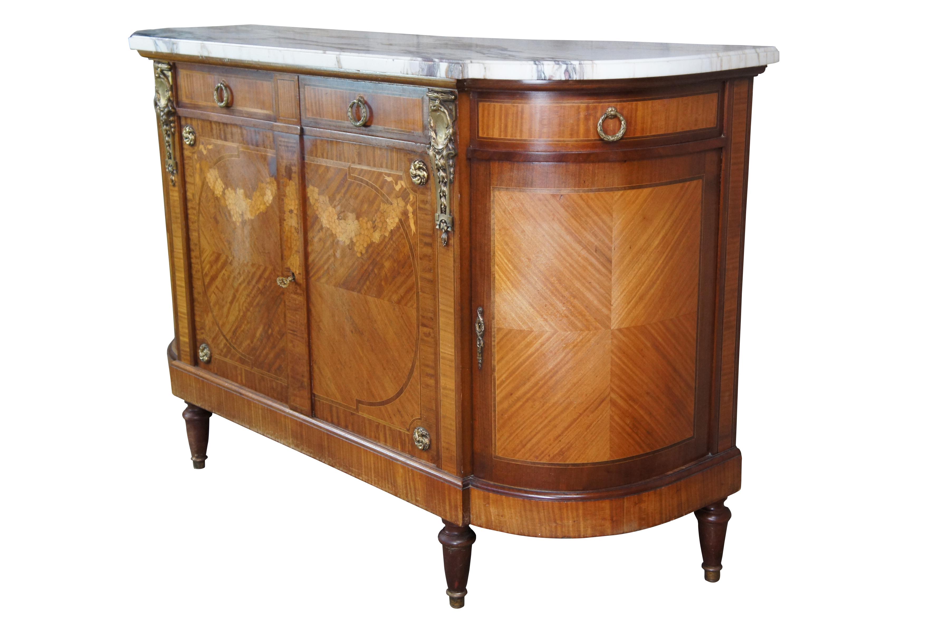 Antique French Louis XVI buffet featuring Neoclassical styling, circa 1870s. A crescent or D-form made from mahogany with a breakfront. Features ormalu mounts, a matchbook parquetry design, inlaid marquetry of grapes and leaves, banding and a marble