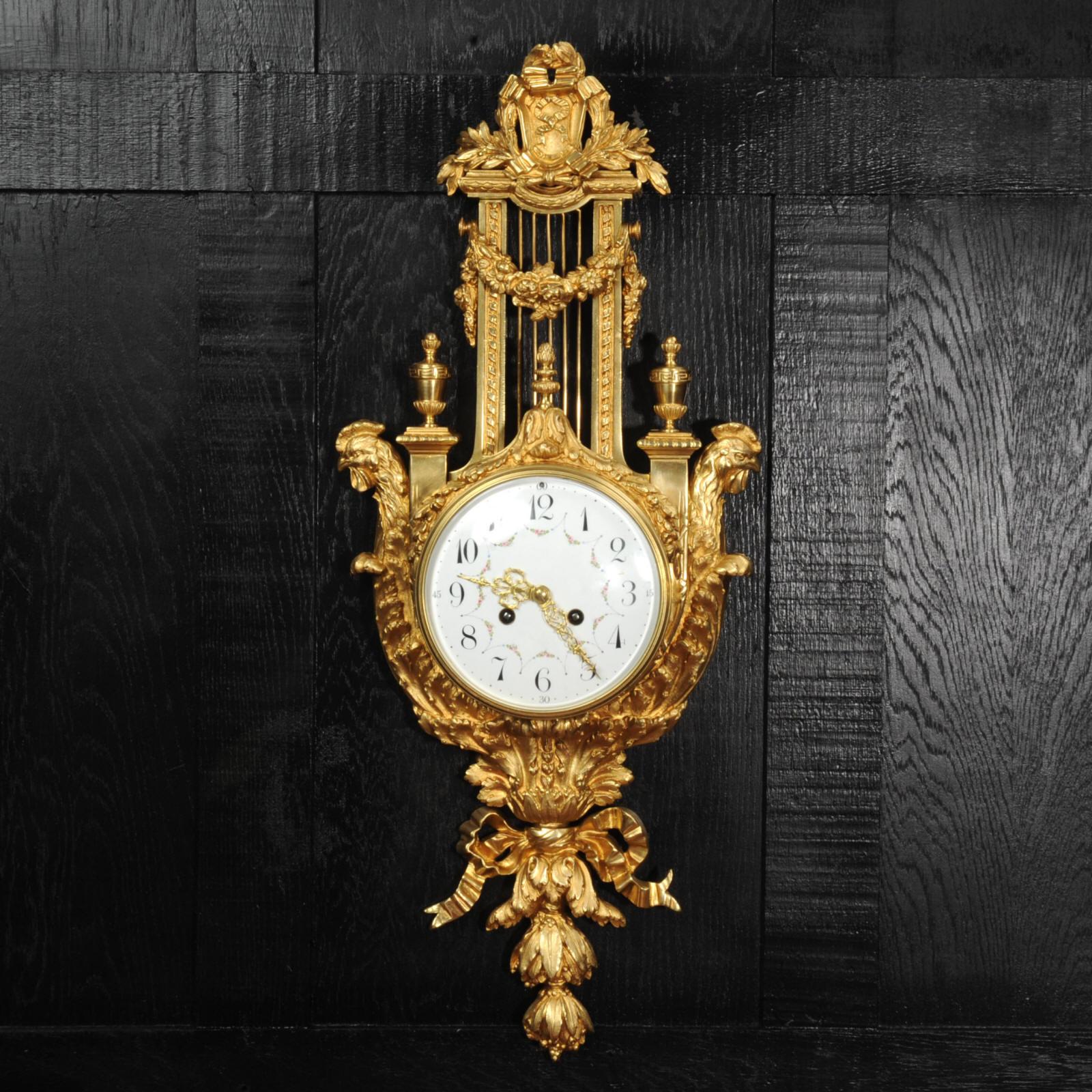 A large and fine antique French cartel wall clock, beautifully modelled in the form of a lyre in ormolu (finely gilded bronze) and dating from circa 1870. The large dial as set in the centre of the instrument, wrapped with acanthus leave scrolls