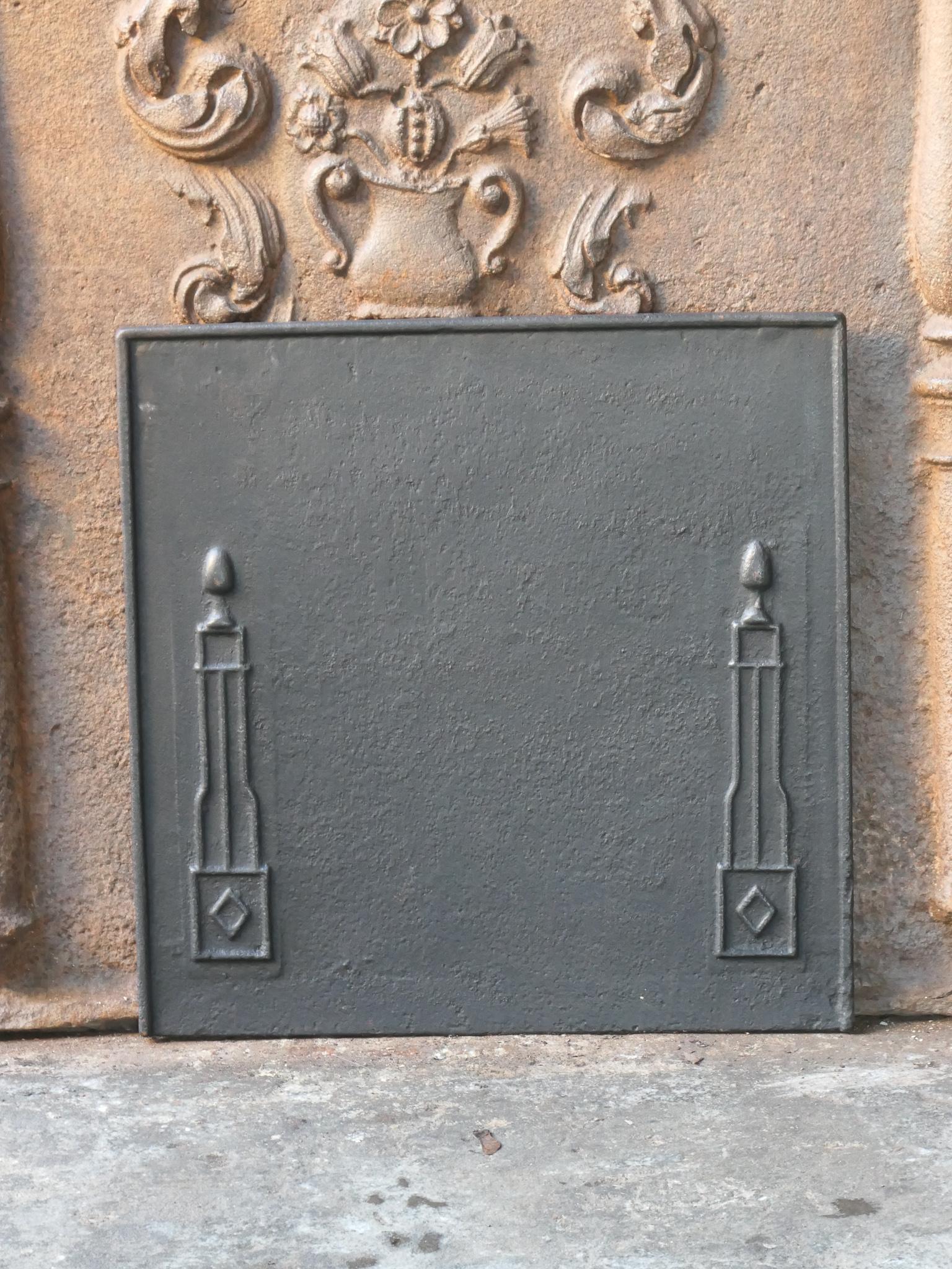 18th - 19th Century French neoclassical fireback with two pillars of freedom. The pillars symbolize the value liberty, one of the three values of the French revolution. 

The fireback is made of cast iron and has a black / pewter patina. It is in