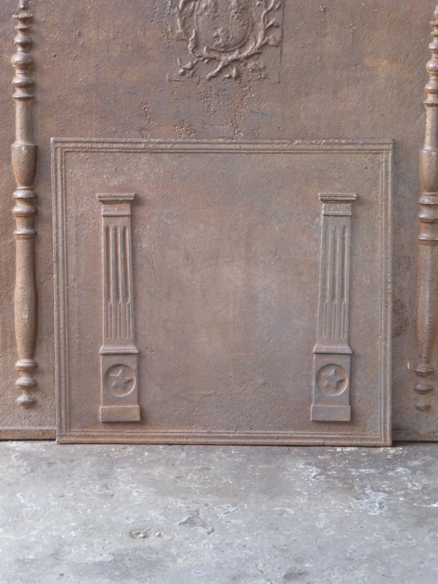 19th Century French neoclassical fireback with two pillars of freedom. The pillars symbolize the value liberty, one of the three values of the French revolution. 

The fireback is made of cast iron and has a natural brown patina. Upon request it