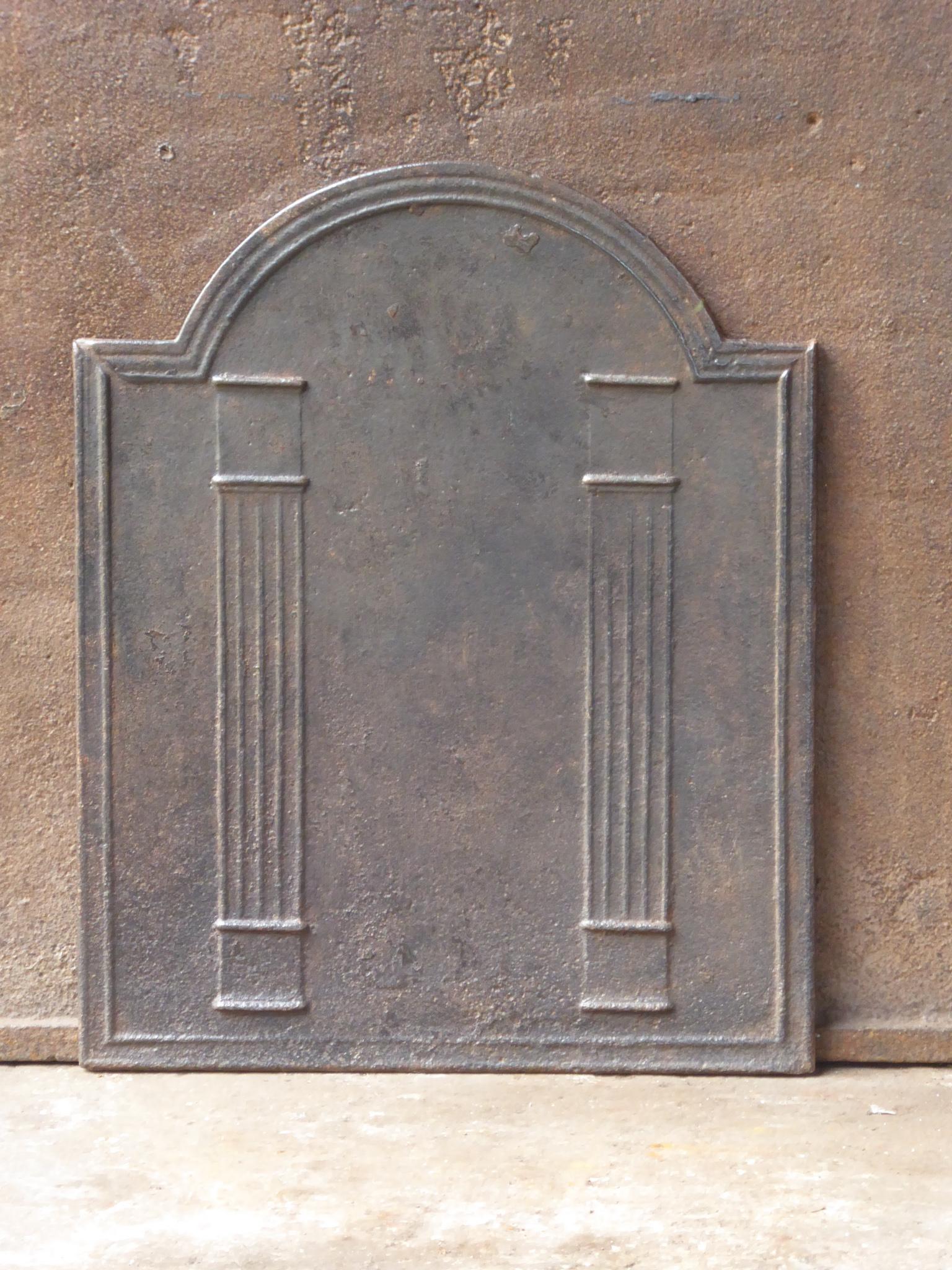 19th Century French neoclassical fireback with two pillars of freedom. The pillars symbolize the value liberty, one of the three values of the French revolution. 

The fireback is made of cast iron and has a natural brown patina. Upon request it