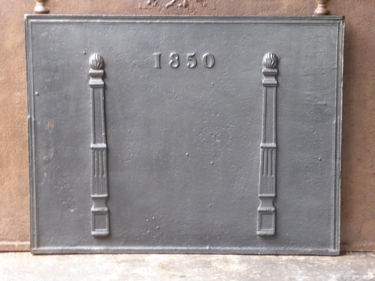 19th century French neoclassical fireback with two pillars of freedom. The pillars stand for the value liberty. This is one of the three values of the French revolution. The date of production, 1850, is also cast in the fireback. The fireback is