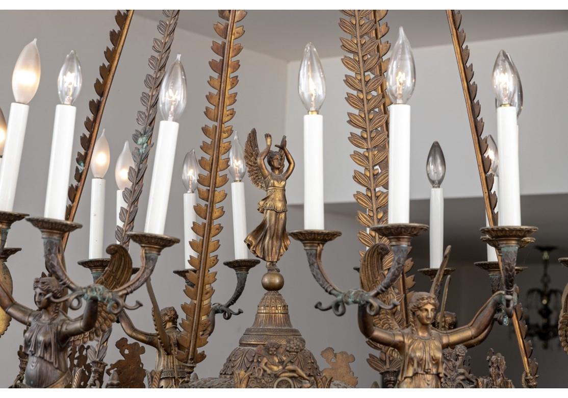 A substantial, detailed and very fine Classical form chandelier. With Six Winged Figures having torch form arms and each figure supporting four lights surrounding a central Winged Figure. The whole raised by Laurel Leaf Garland chains suspended from