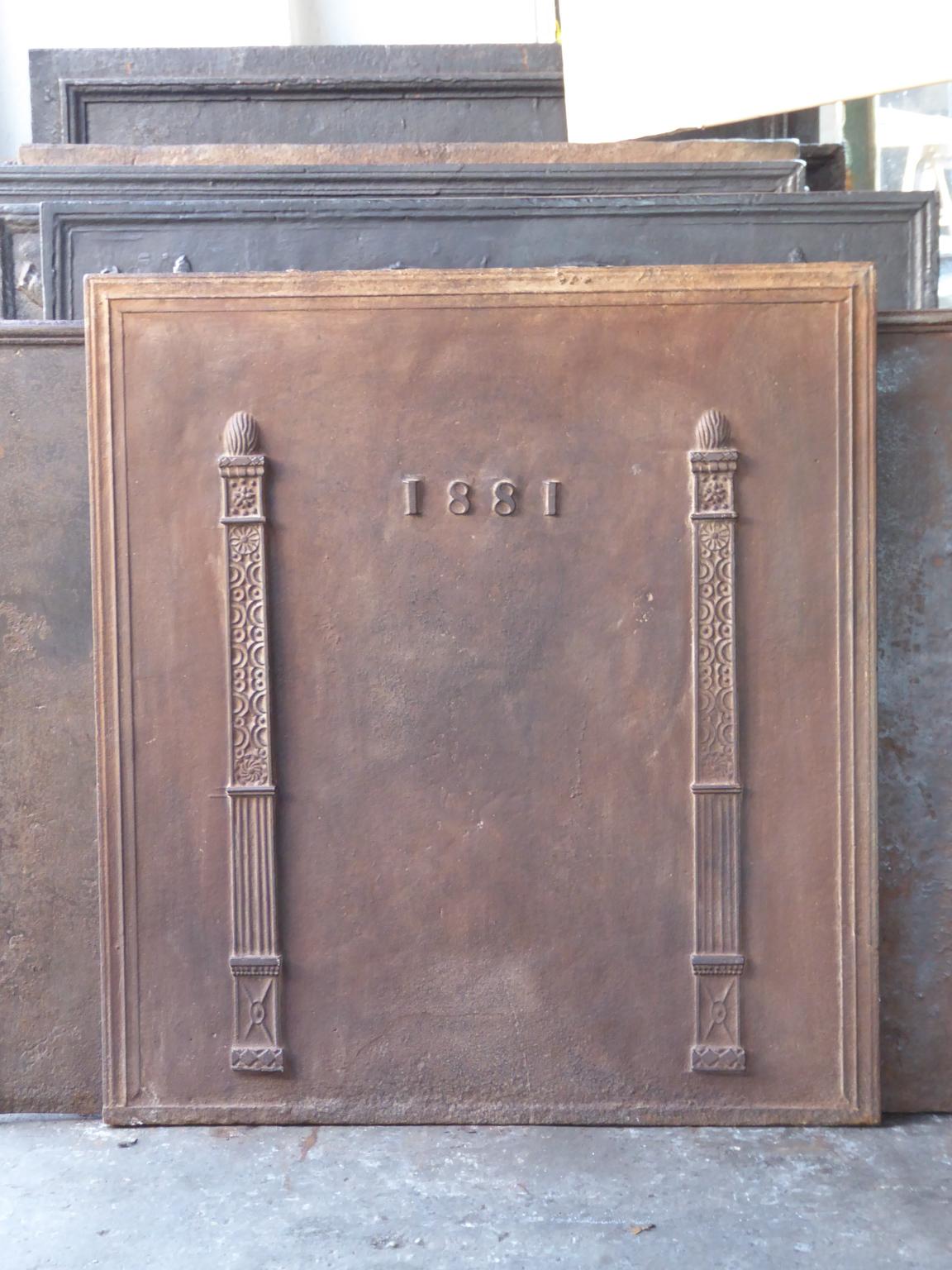 19th century French neoclassical style fireback with two pillars of freedom. The pillars symbolize the value liberty, one of the three values of the French revolution. The date of production of the fireback, 1881, is also cast in the fireback

The