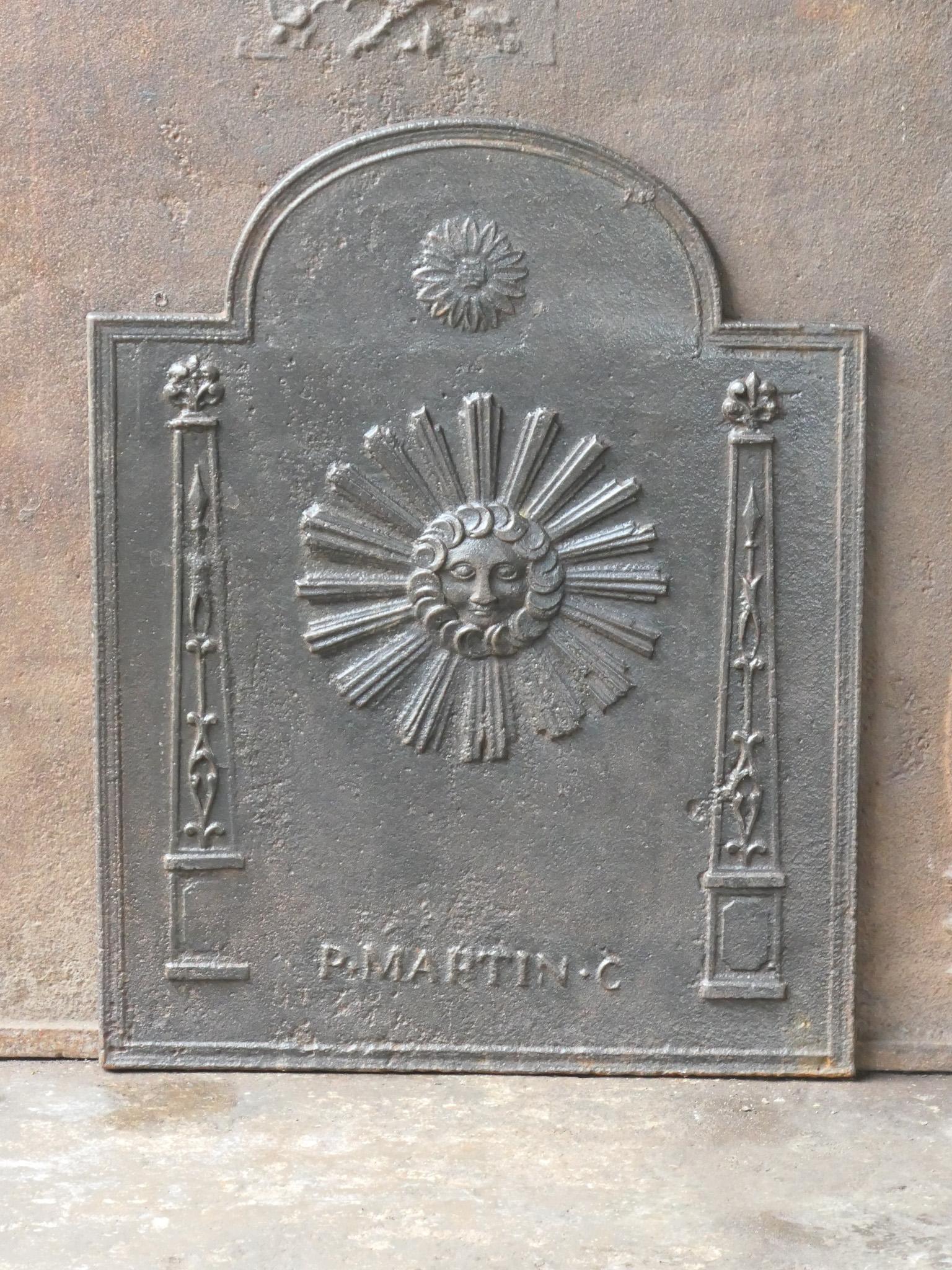 18th - 19th century French neoclassical period fireback with the sun. The sun is symbol voor king Louis XIV.

The fireback is made of cast iron and has a natural brown patina. Upon request it can be made black / pewter at no extra cost. It is in a