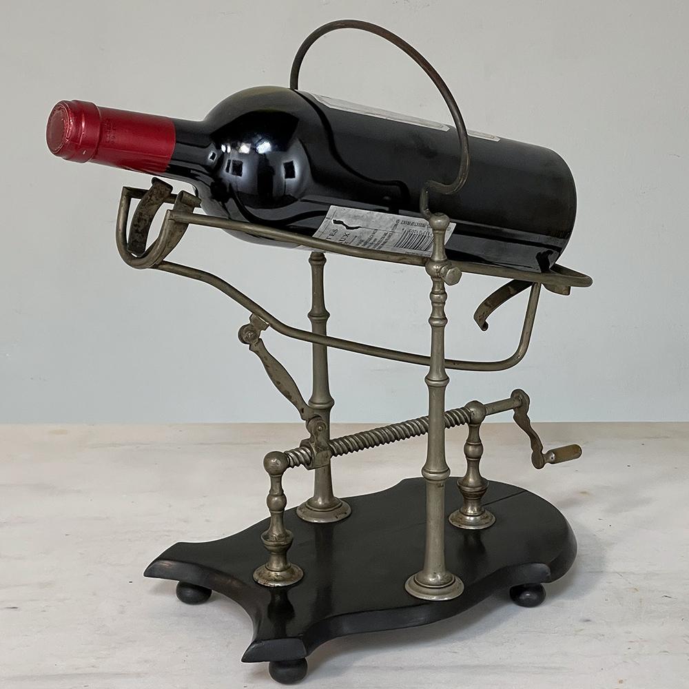 Antique French Nickeled brass Mechanical Wine cradle ~ Server will make a splendid addition to the wine-connoisseur's collection! Hand-crafted from solid brass that has been nickeled, it rests on a contoured four-footed blackened wood base upon