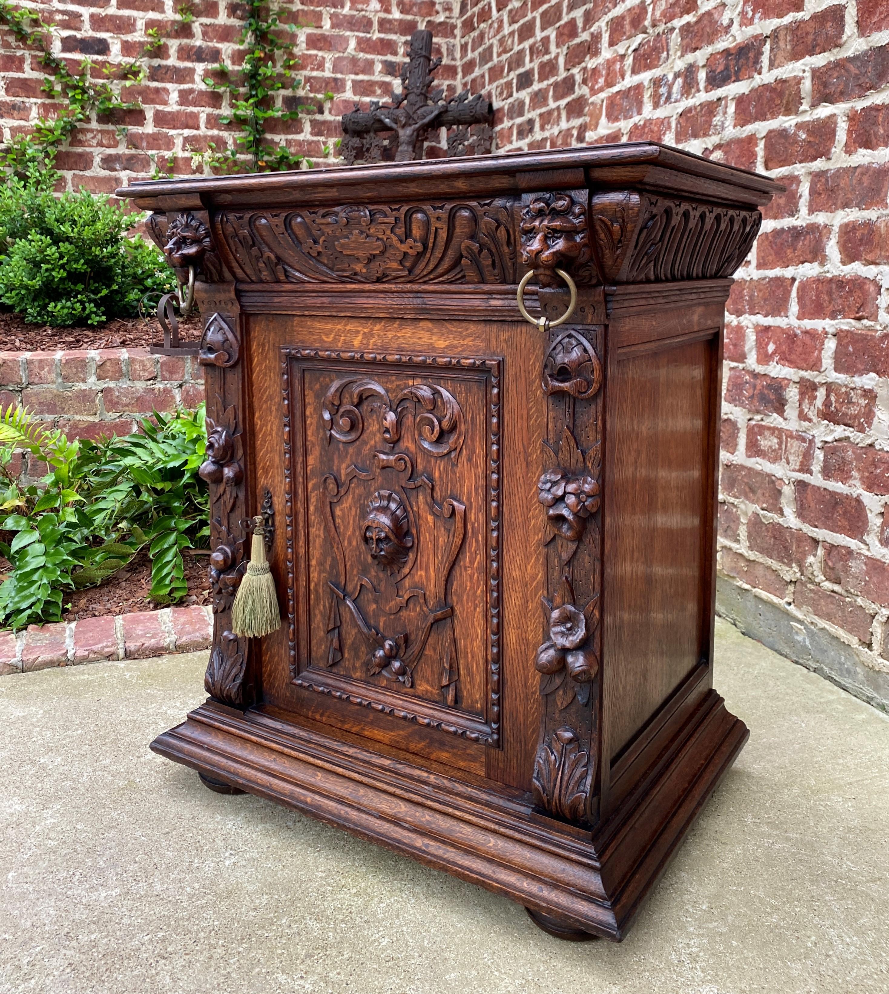 Gorgeous highly carved Antique French oak end table, nightstand, or side cabinet ~~Renaissance Revival
~~c. 1880s

Beautifully carved lion masks with brass rings on corners~~wonderful beveled edge top.

Use as an end table or side cabinet