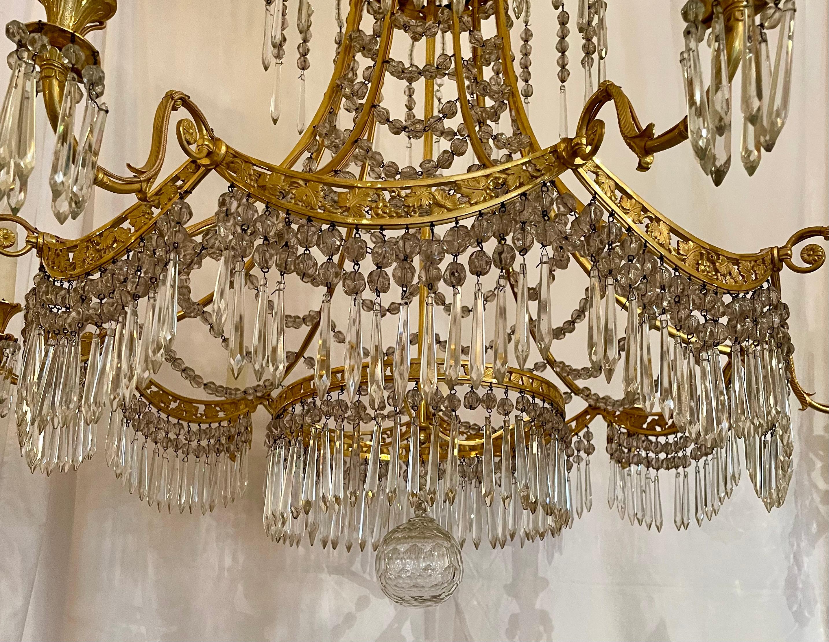 Antique French northern European empire style gold bronze and crystal chandelier.