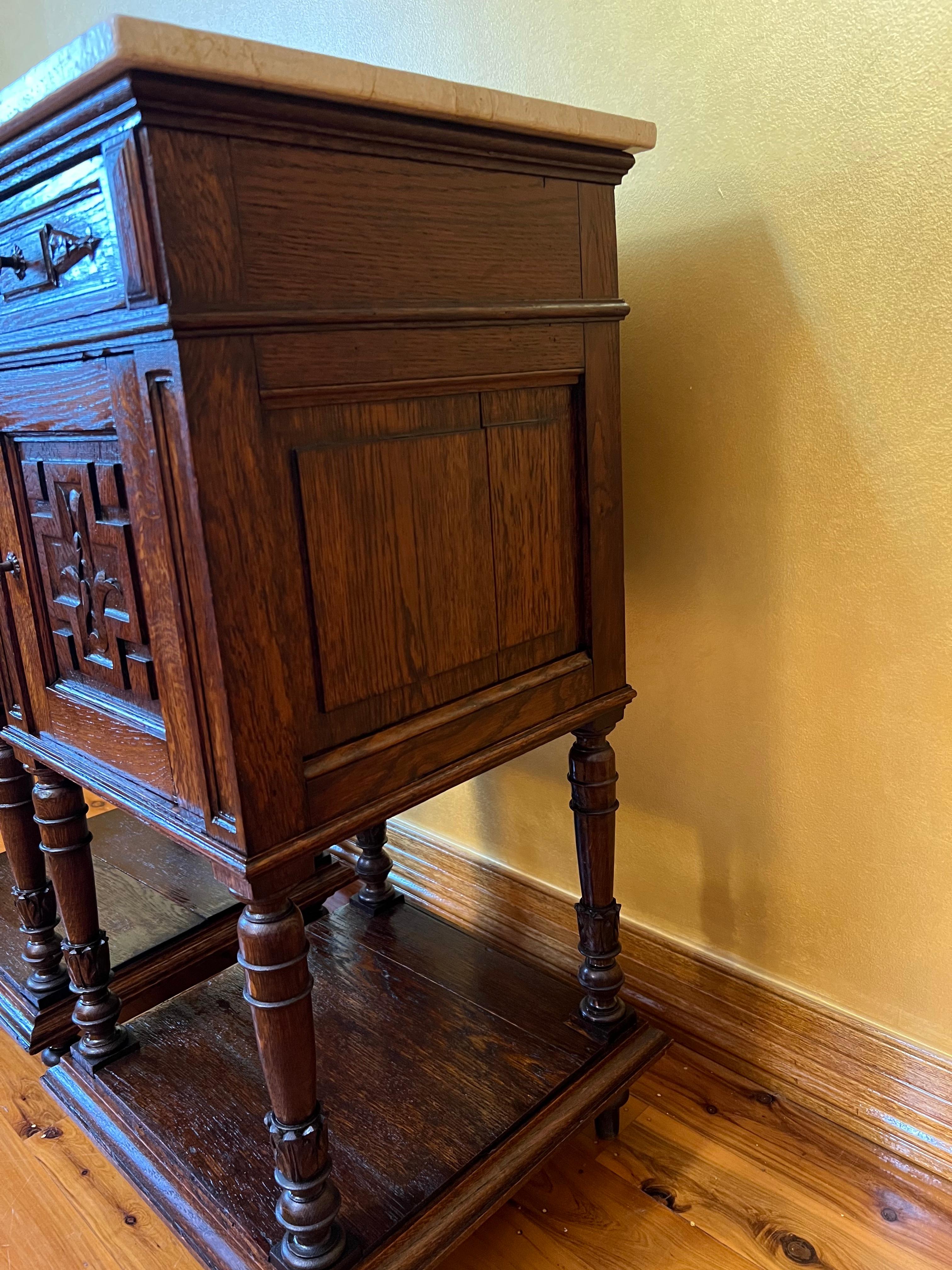 Marble topped nightstand, with carved detail on front door and drawer, shelf to display on bottom, straight legs with round detail.

Circa: 19th century

Material: Oak & Marble

Country of Origin: France

Measurements: 87cm high, 38.5cm