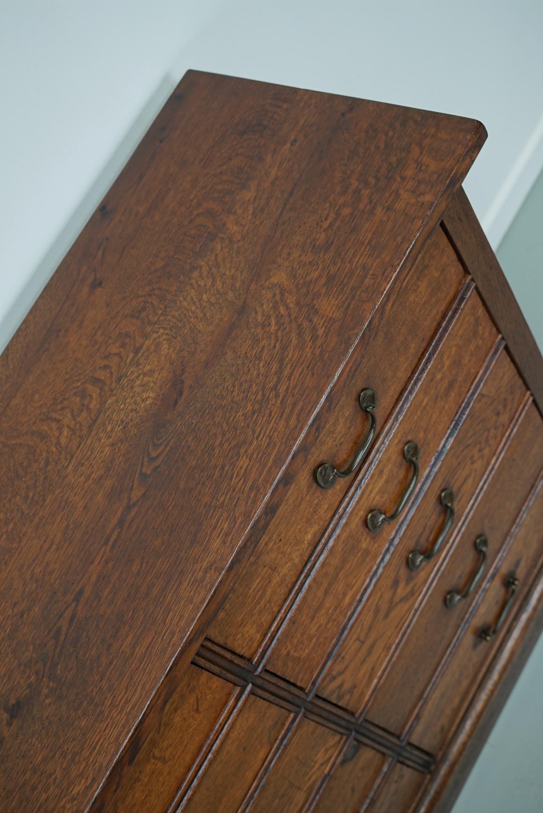 This apothecary cabinet was made in the early 20th century in France from oak. It features 20 drawers with brass handles. The interior dimensions of the drawers are: DWH 29 x 41 x 8 cm.