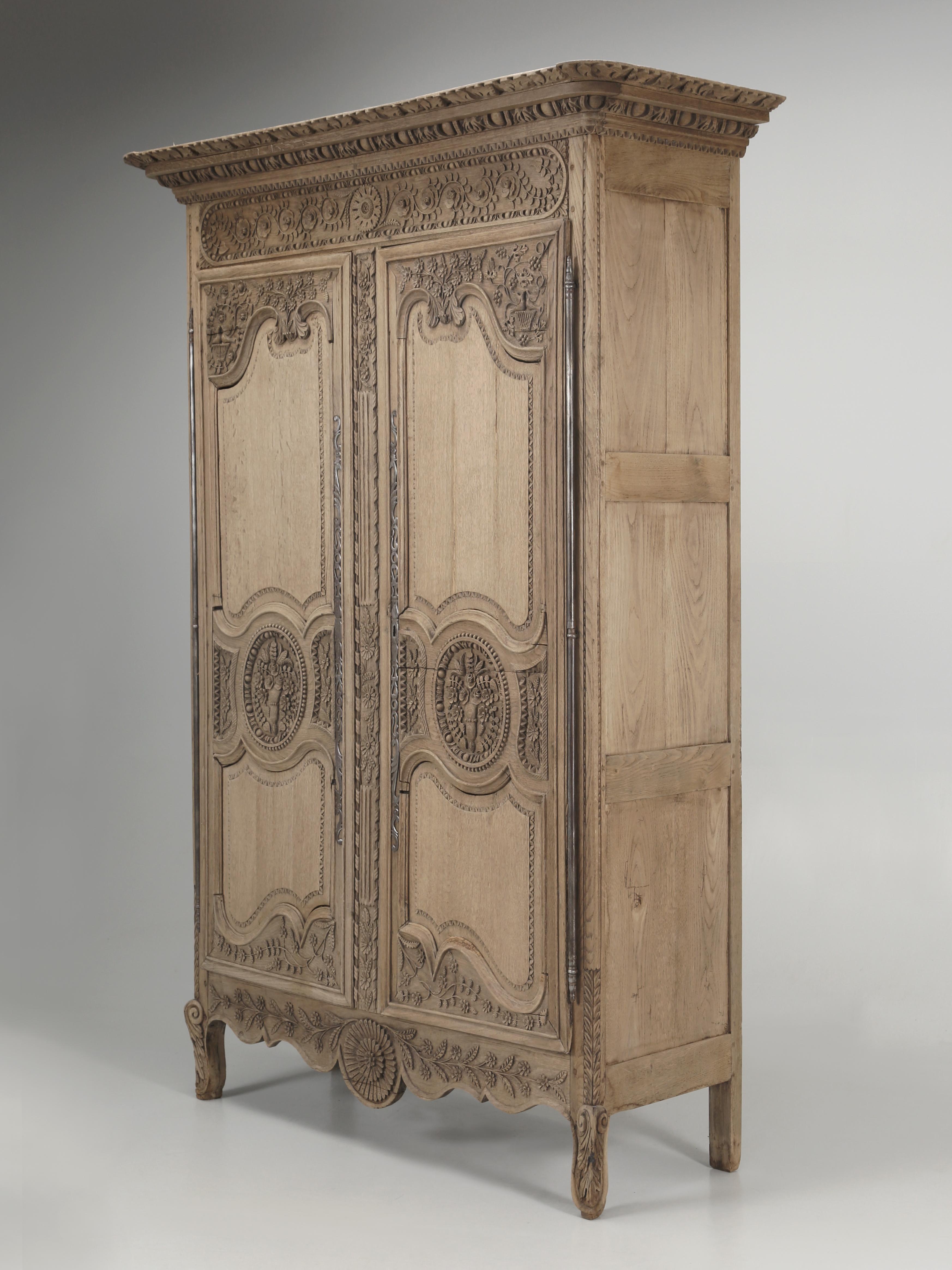 Antique French Oak Armoire from the Normandy region of France which were commonly referred to as Wedding Armoires. In France, this was the traditional French custom for a father to gift his newborn daughter, an Armoire carved with symbols and in