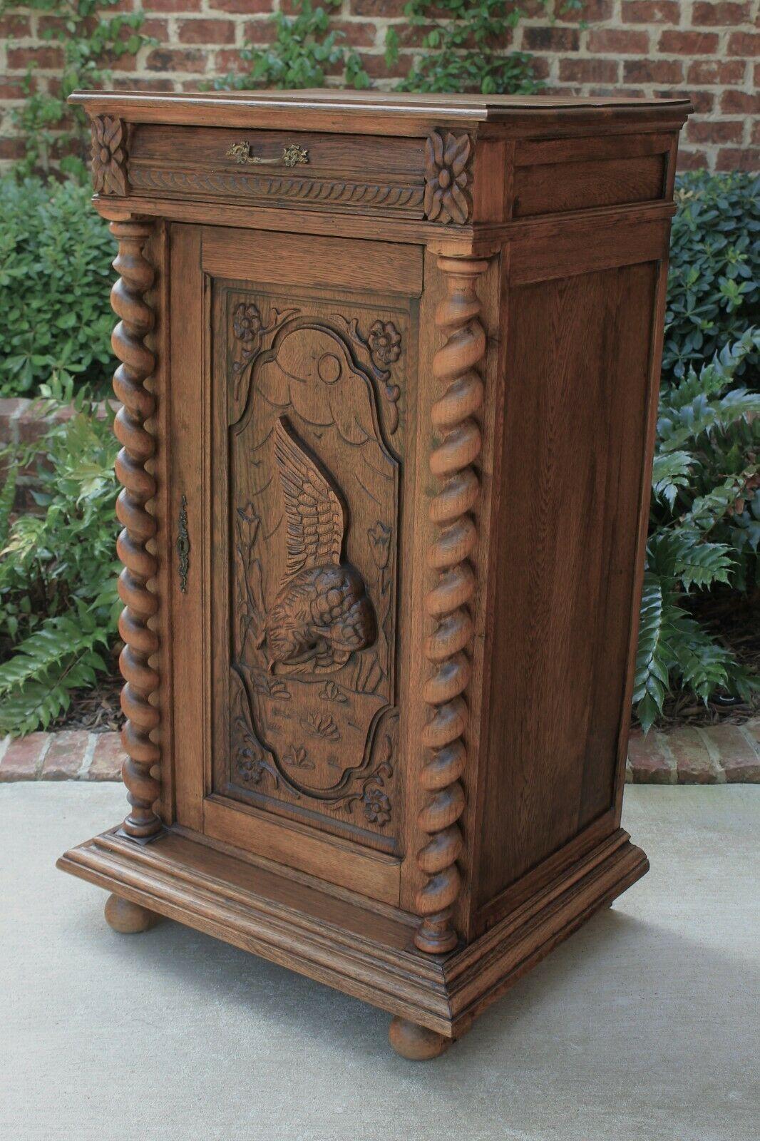 Antique French oak barley twist Black Forest bar, wine liquor cabinet, cupboard, server or buffet~~c. 1880s

Fabulous antique French carved Black Forest cabinet with meticulous hand-carved bird on door flanked by 
