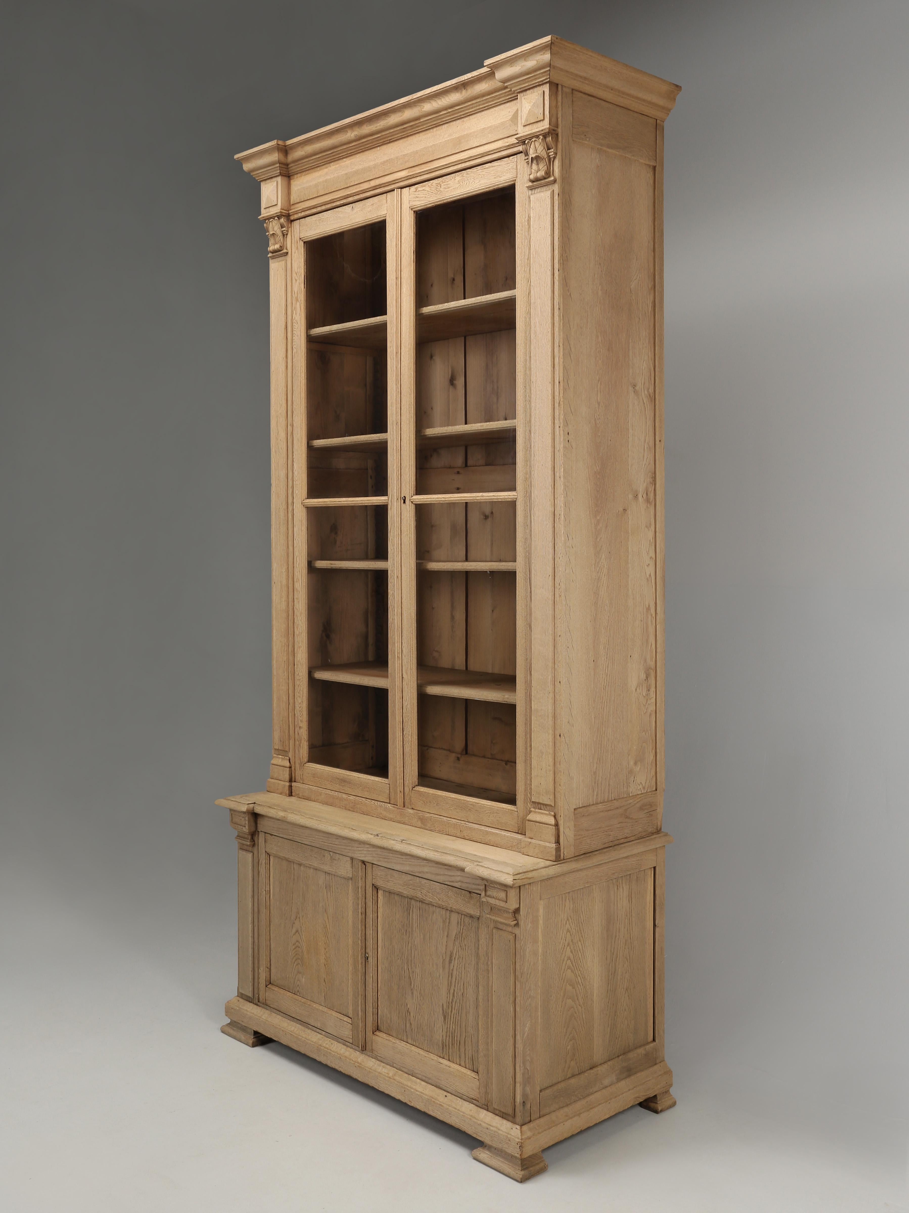 Magnificent antique French white oak bookcase, with 2-doors, both retaining their original wavy glass. We located this antique French bookcase, china cabinet, or display cabinet in the town of Joigny, which is located in the north-central part of