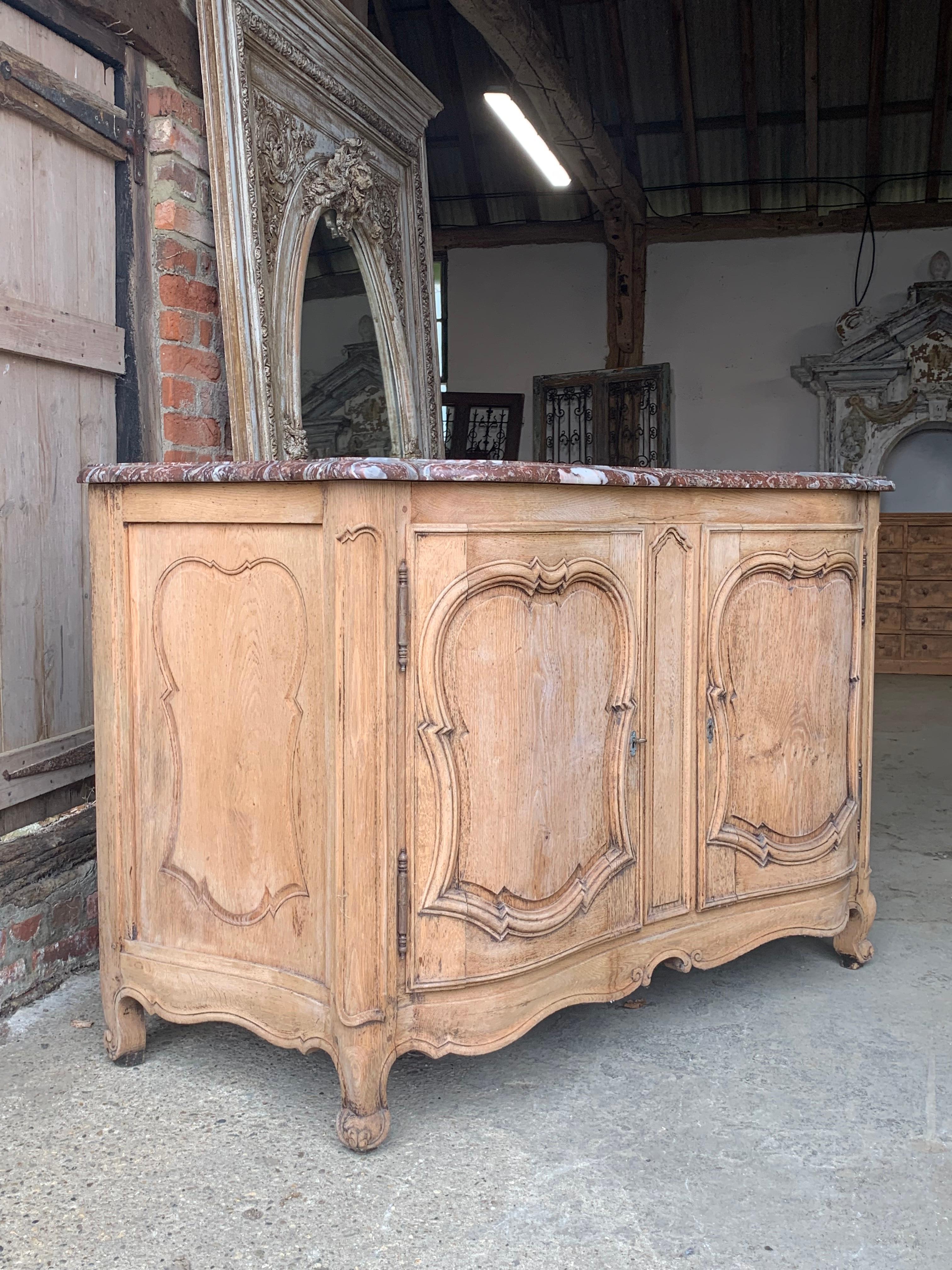 A beautiful quality early 19th century French buffet made from bleached oak which has nice curved sides and front. With a lovely quality marble top. 