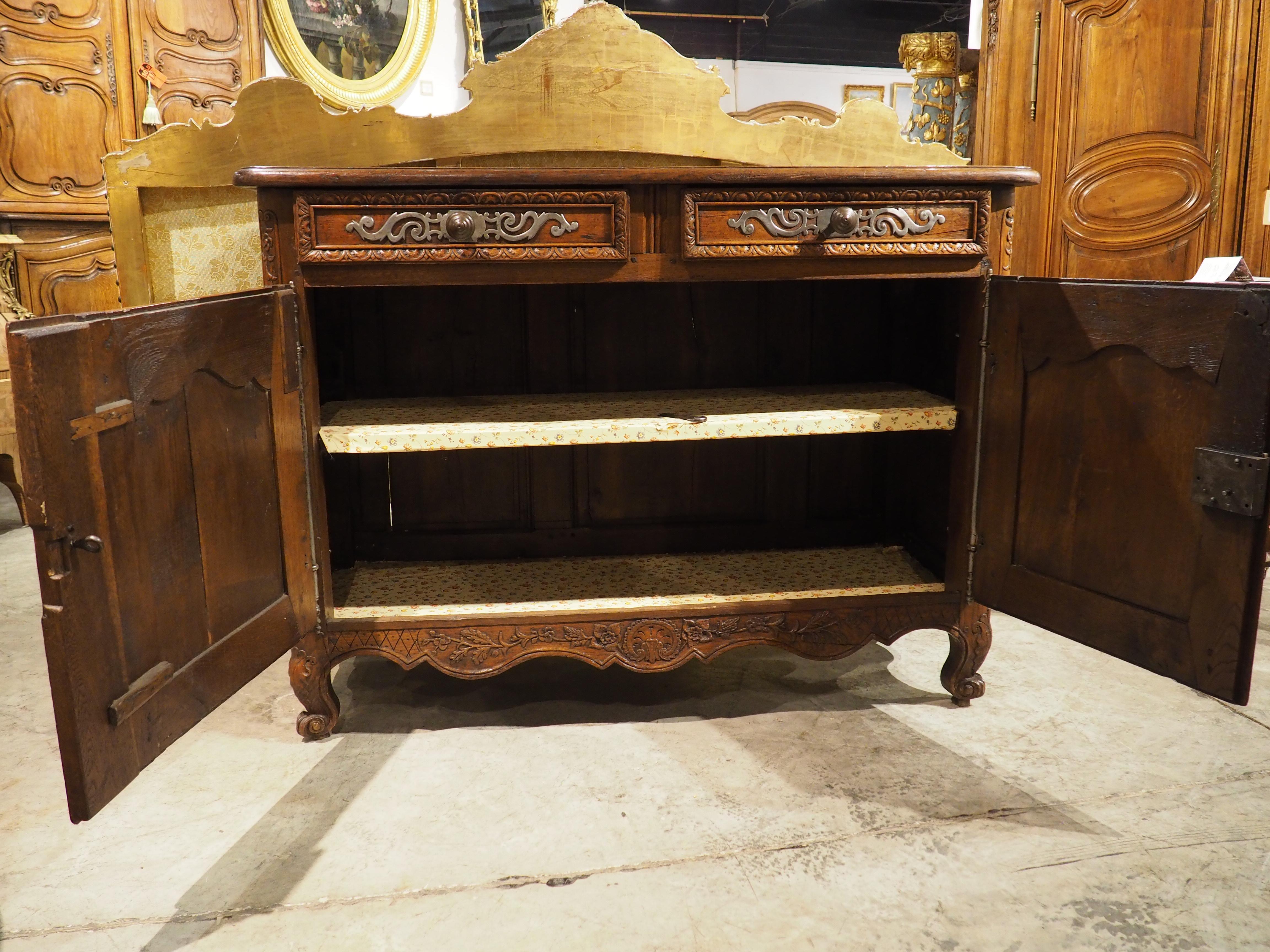 More information coming soon…

Hand-carved in Normandy, France, circa 1830, this beautiful oak buffet has a floral theme, with numerous carvings of floral margents on the doors, apron, and legs, but also an interior lined with floral print paper. 