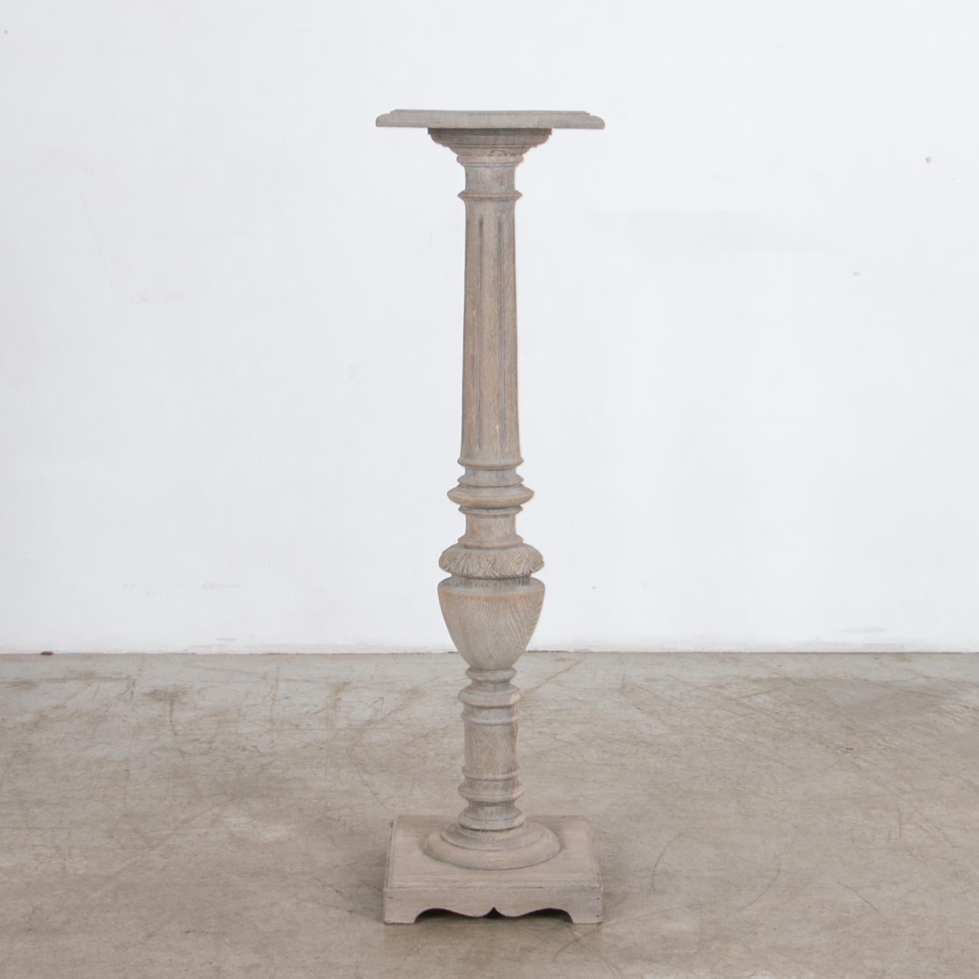 An elegant perch. A turned wood column of Cerused oak, originally from circa 1900 France, updated with a contemporary finish. With a characteristic carved motif, floral elements mix with geometric pattern, topped with a miniature square table and a