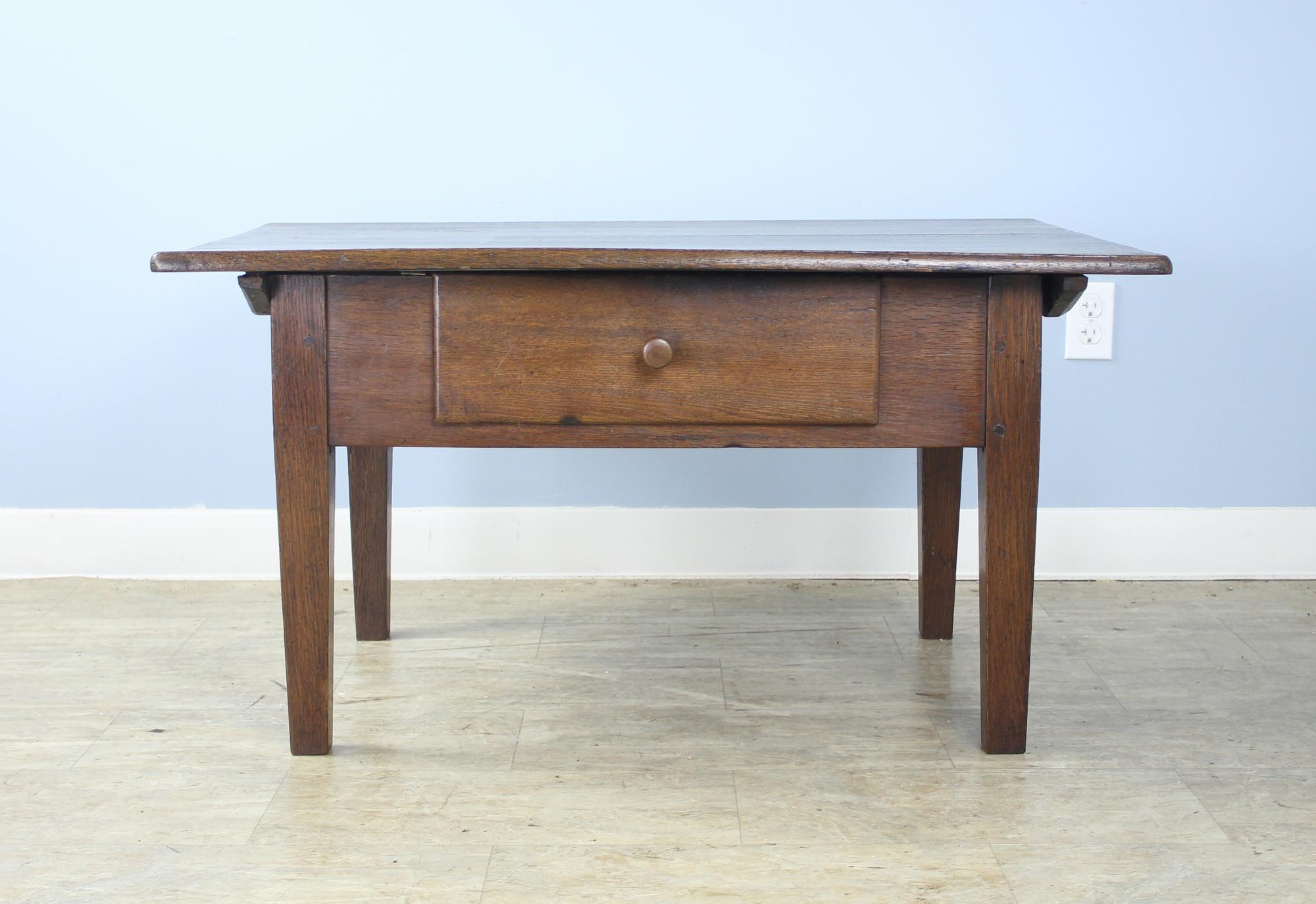 Good dark oak French coffee table with deep useful drawer and attractive supports.
