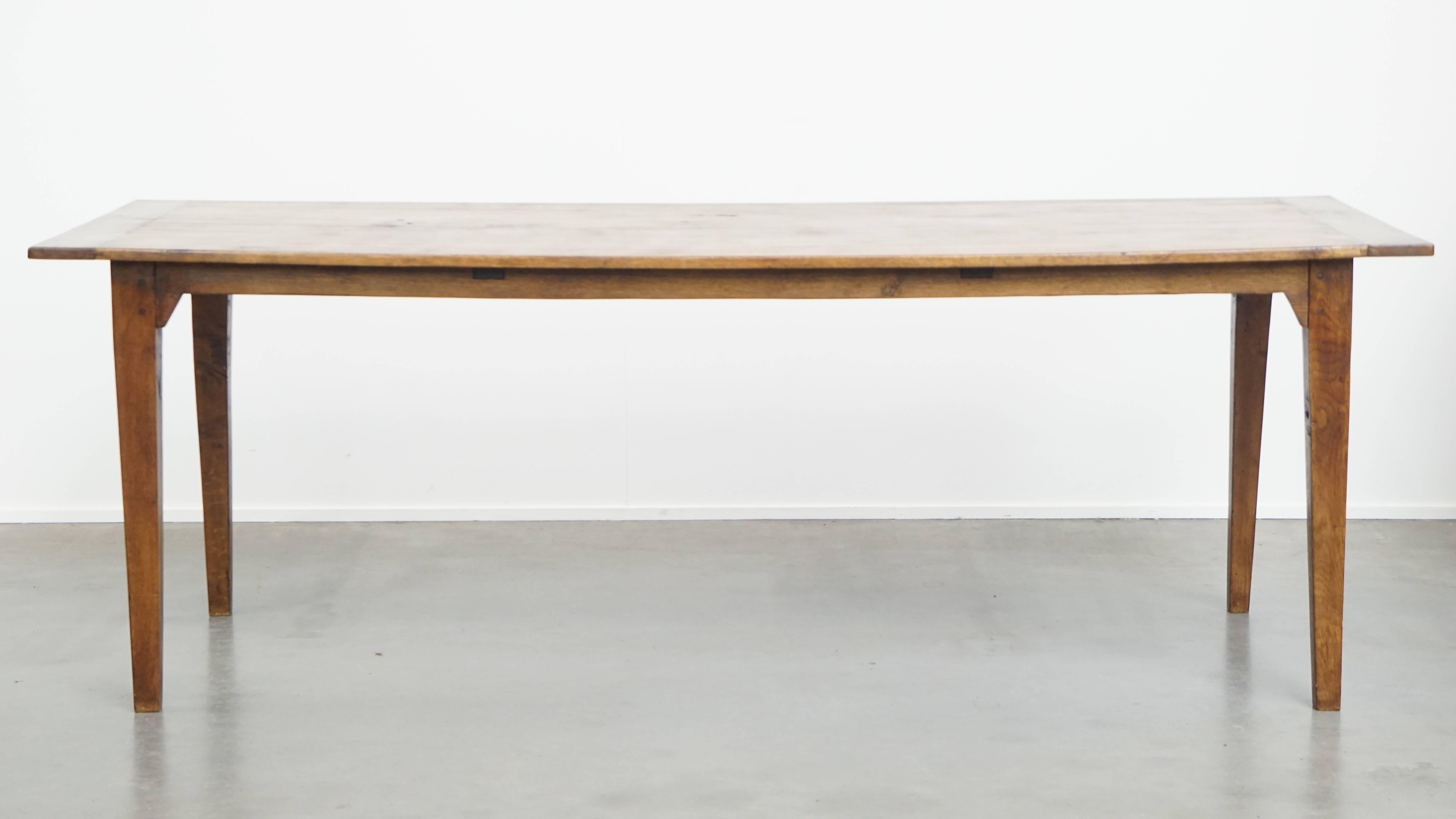 Offered: this characterful antique French oak dining table for 6 to 8 people, featuring original details and a beautiful patina.

This wonderful antique French oak dining table is an ideal, timeless addition to almost any interior, comfortably