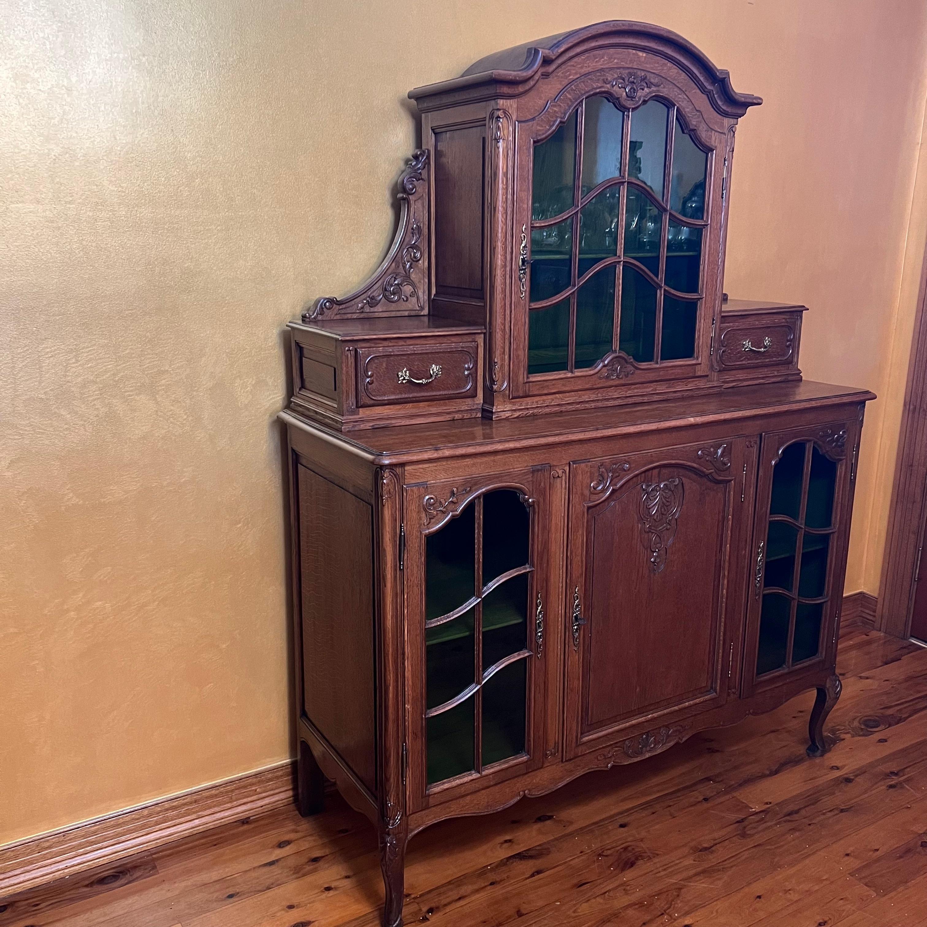 French windows on top and two panels on bottom, two drawers on top and two shelves of storage on bottom, lead light green glass, lock on top works locks on bottom dont work, this item has been French Polished 

Circa: 19th Century 

Material: