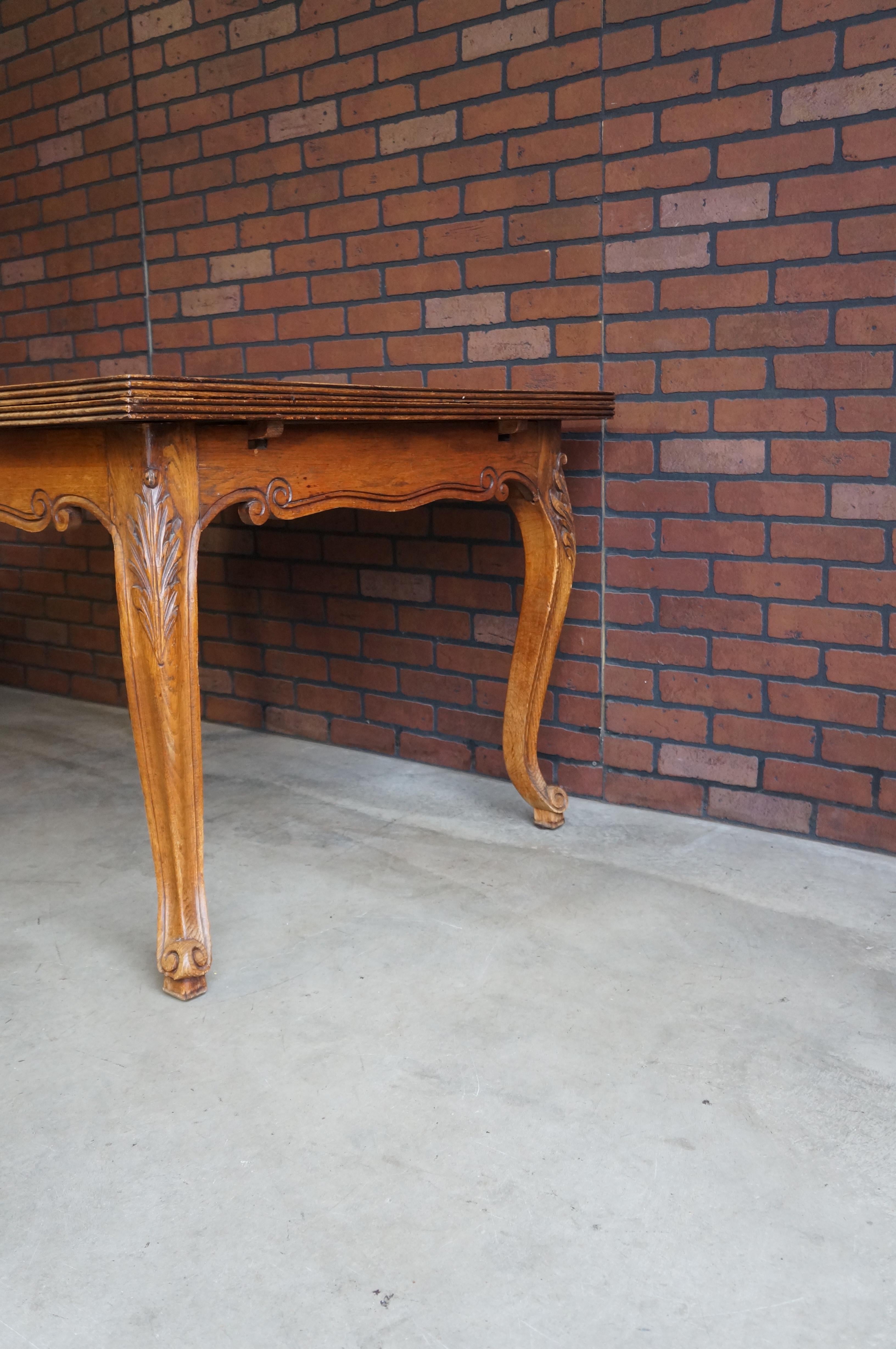 History, craftsmanship and the beauty of Oak pattern veneer top combine in this lovely antique French dining table. The draw leaf design allows the leaves to be hidden under the top and then pulled out to extend for extra seating as needed. The
