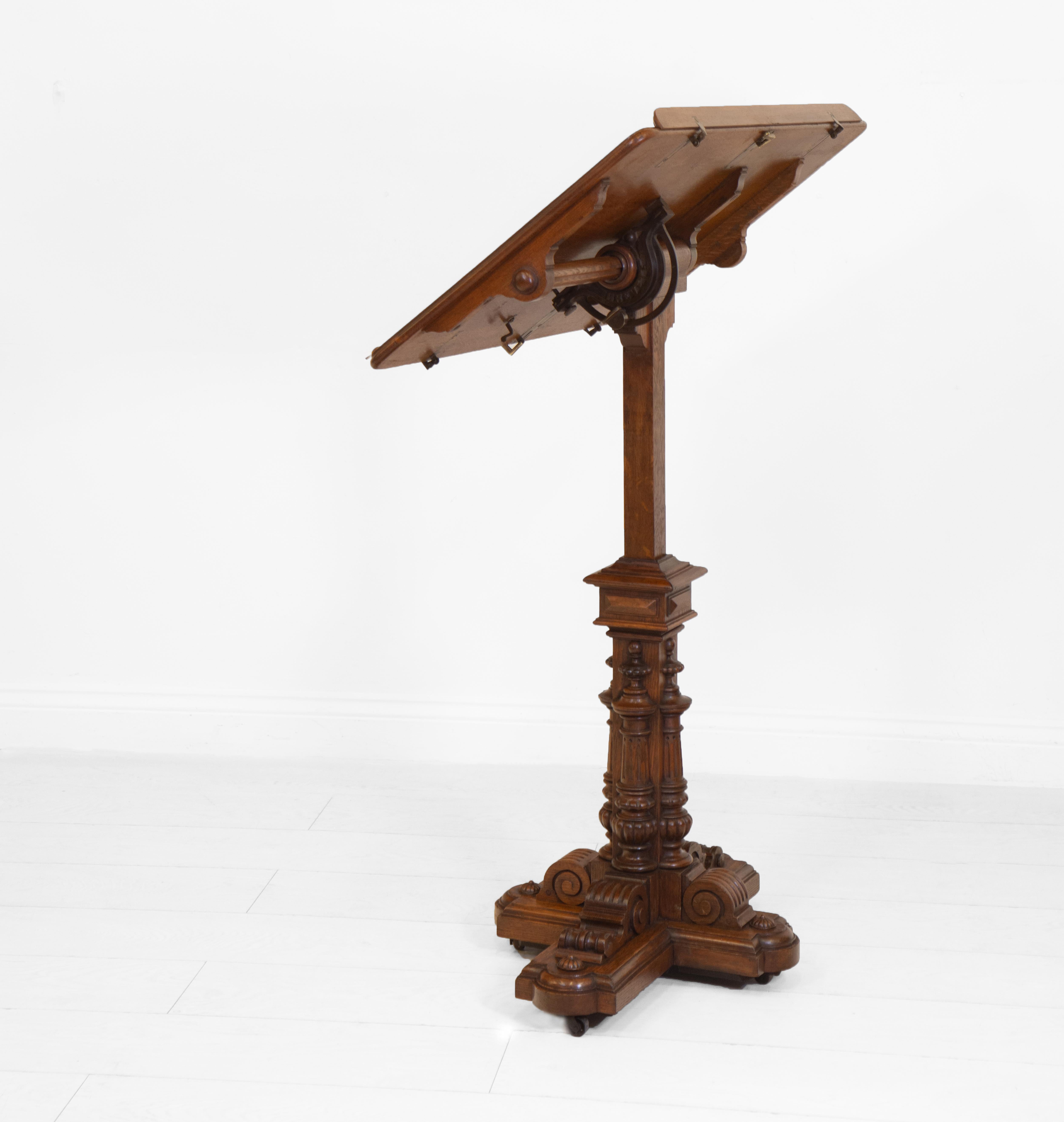 A 19th century French oak fully adjustable reading table in the Ecclesiastical Gothic style. Circa 1880.

The table has a rounded rectangular plateau with two book rests, terminating on a turned and carved column with weighted quatrefoil base, and