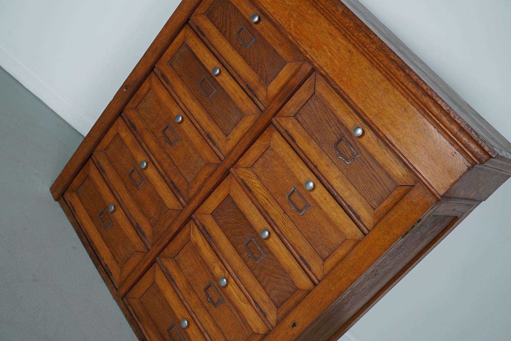 This oak filing cabinet with metal hardware was made around the 1930s in France. It features 10 folding doors with 5 large compartments. The interior dimensions of the compartments are: D 30 x W 85 x H 16 cm.