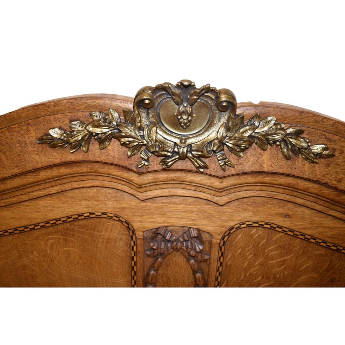 Antique French double bed with gilt and tumbridge ware inlay, brass centre detail and detailed carved ribbons to both front and head boards.

Also Available matching bed side table

Size: Double bed

Circa: 1890

Material: Oak

Country of